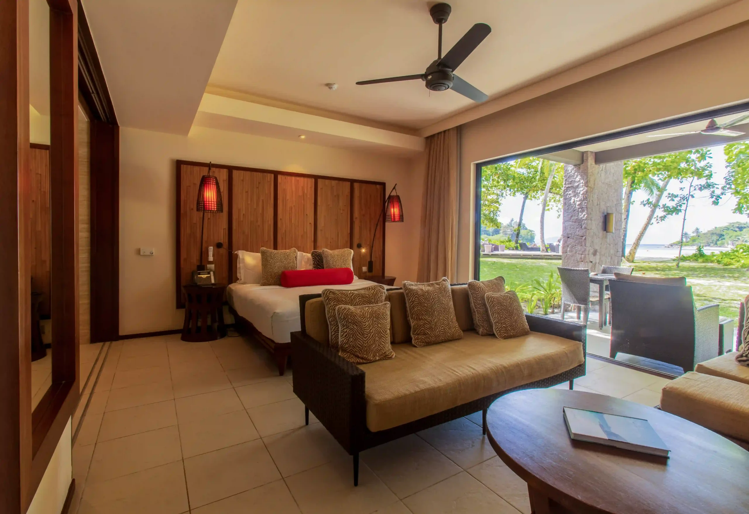 constance ephelia junior suite room with bedroom living area and tropical decor