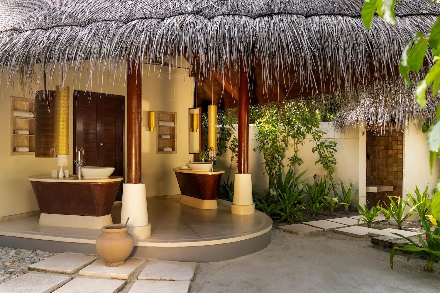 constance halaveli maldives beach villa featuring a serene outdoor bathroom setting