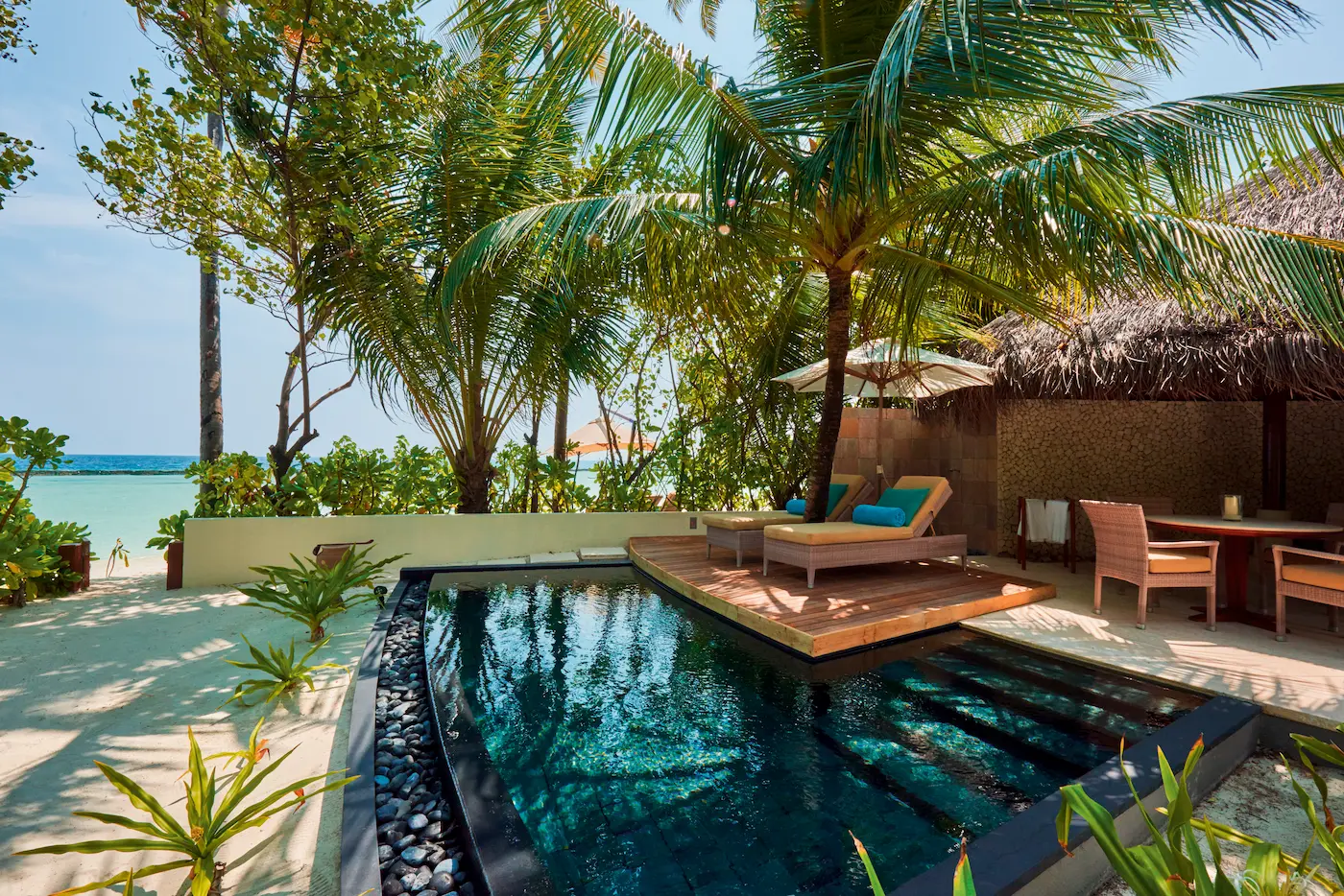 constance halaveli maldives beach villa featuring a relaxing sunbed area