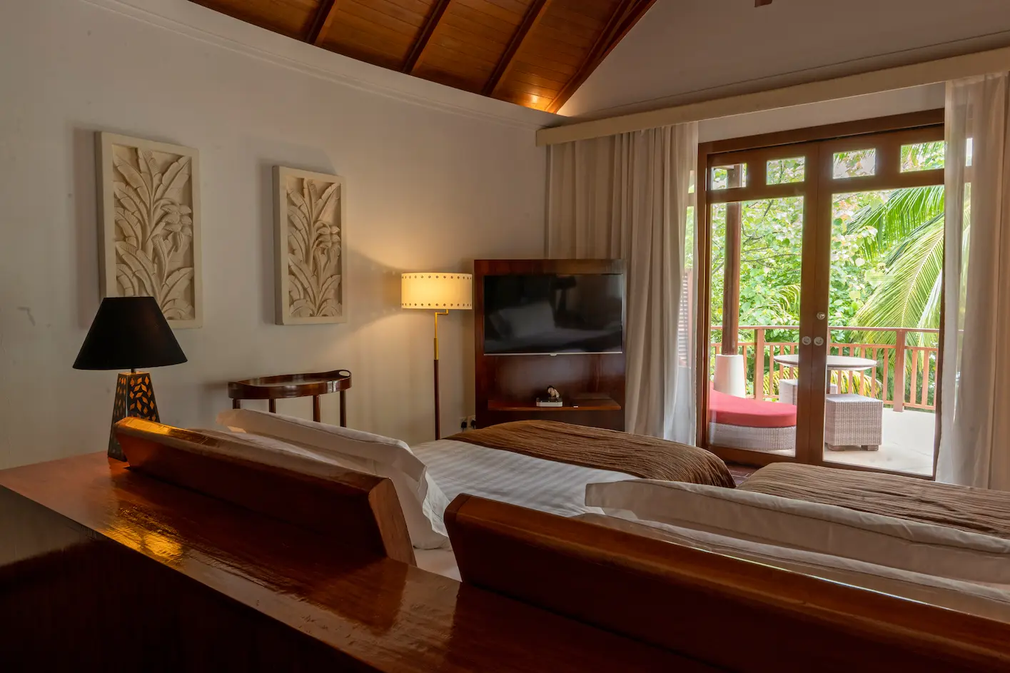 constance halaveli maldives double storey beach villa bedroom featuring a spacious king bed room setting