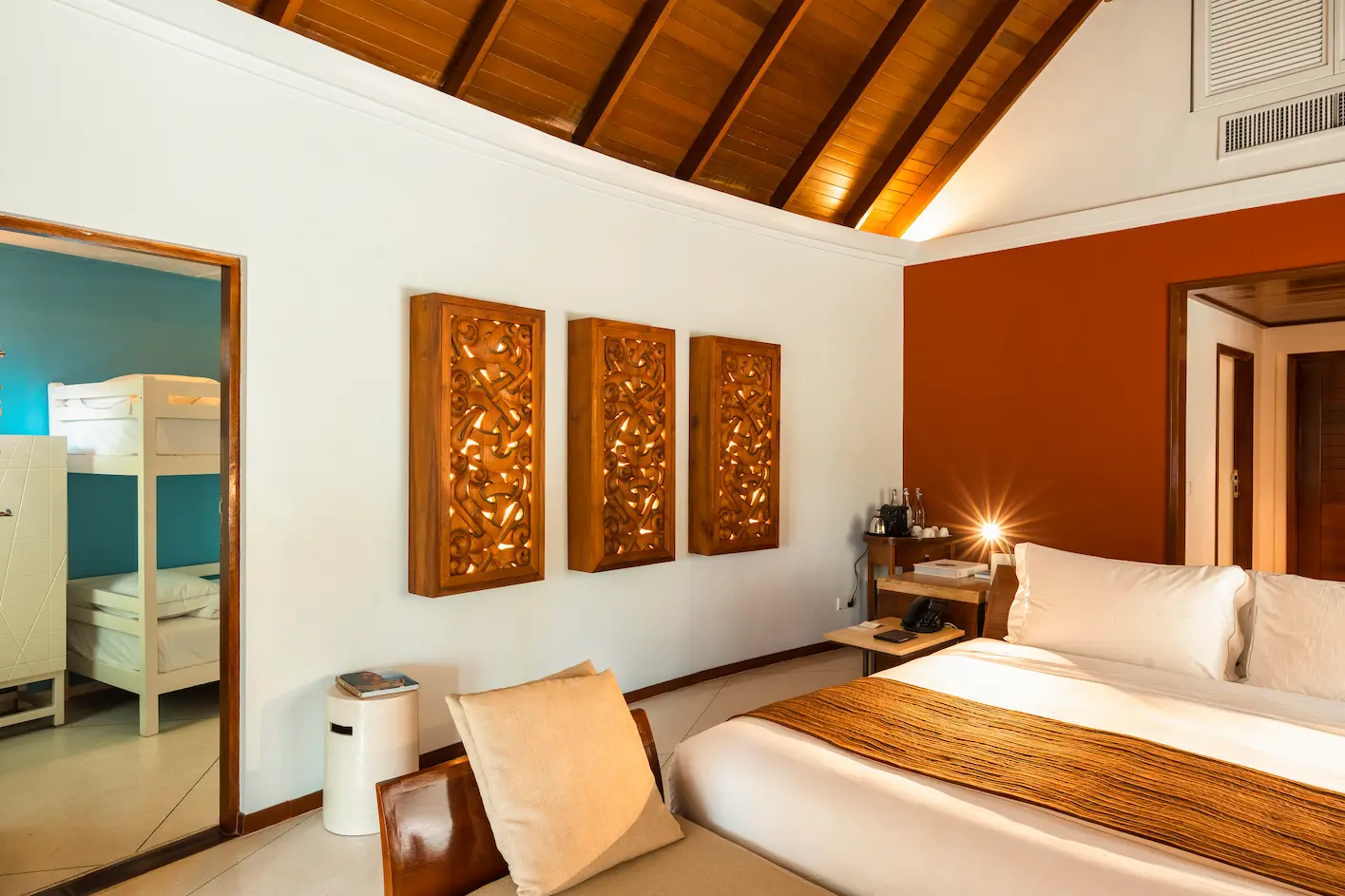constance halaveli maldives family villa master bedroom featuring a spacious and elegant bed