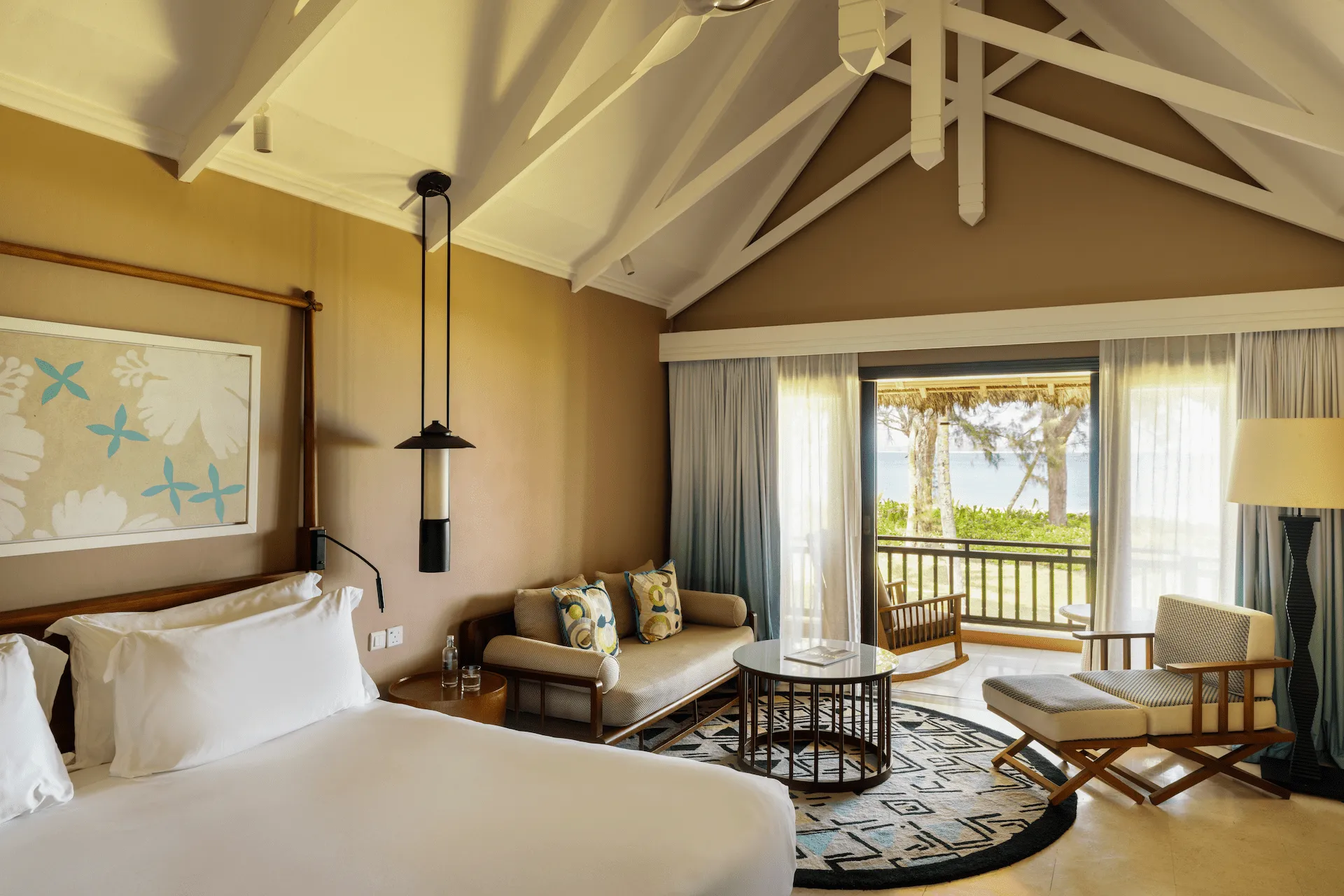 constance lemuria junior suite bed view overlooking bedroom and tropical surroundings