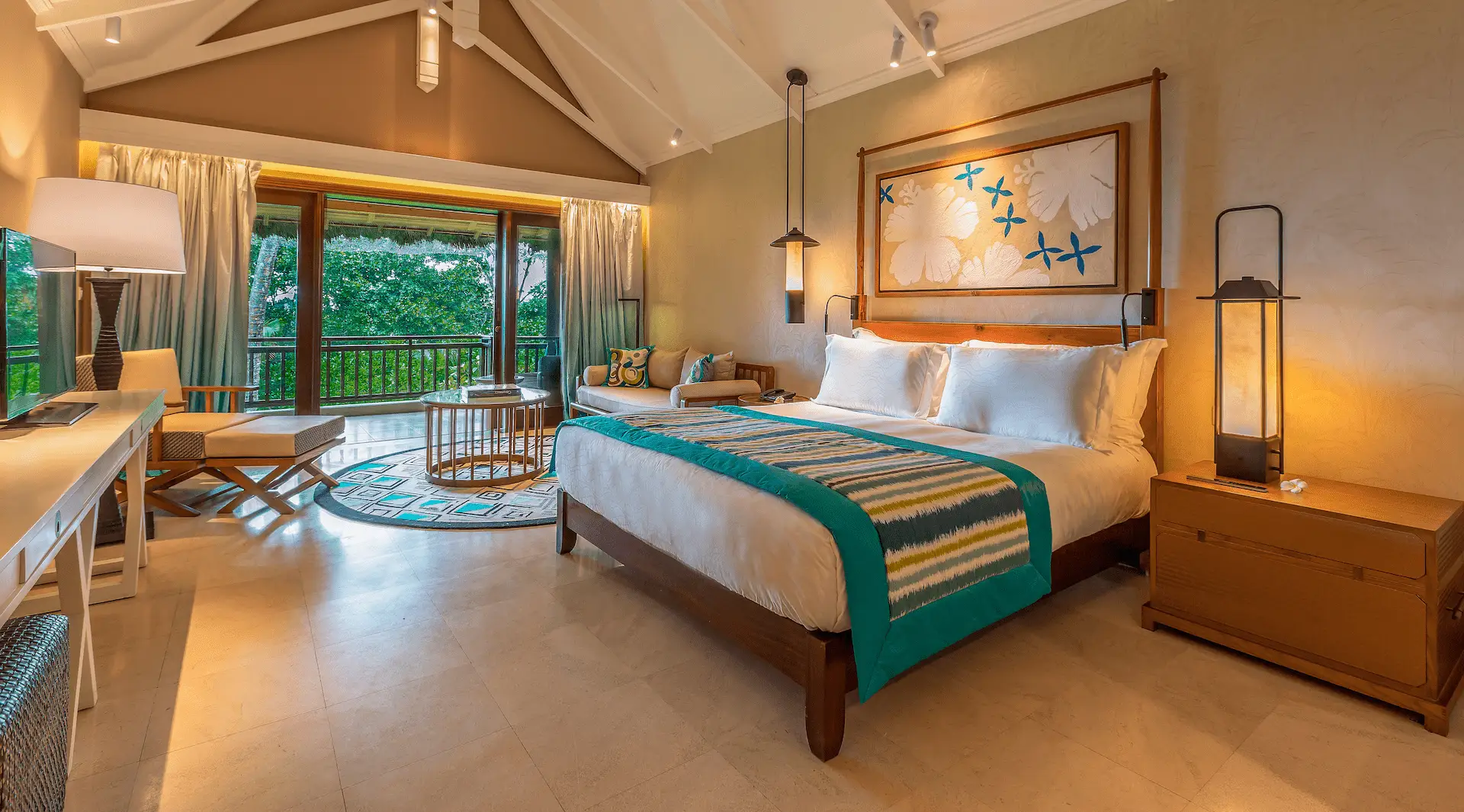 constance lemuria junior suite bedroom view with king bed and tropical scenery
