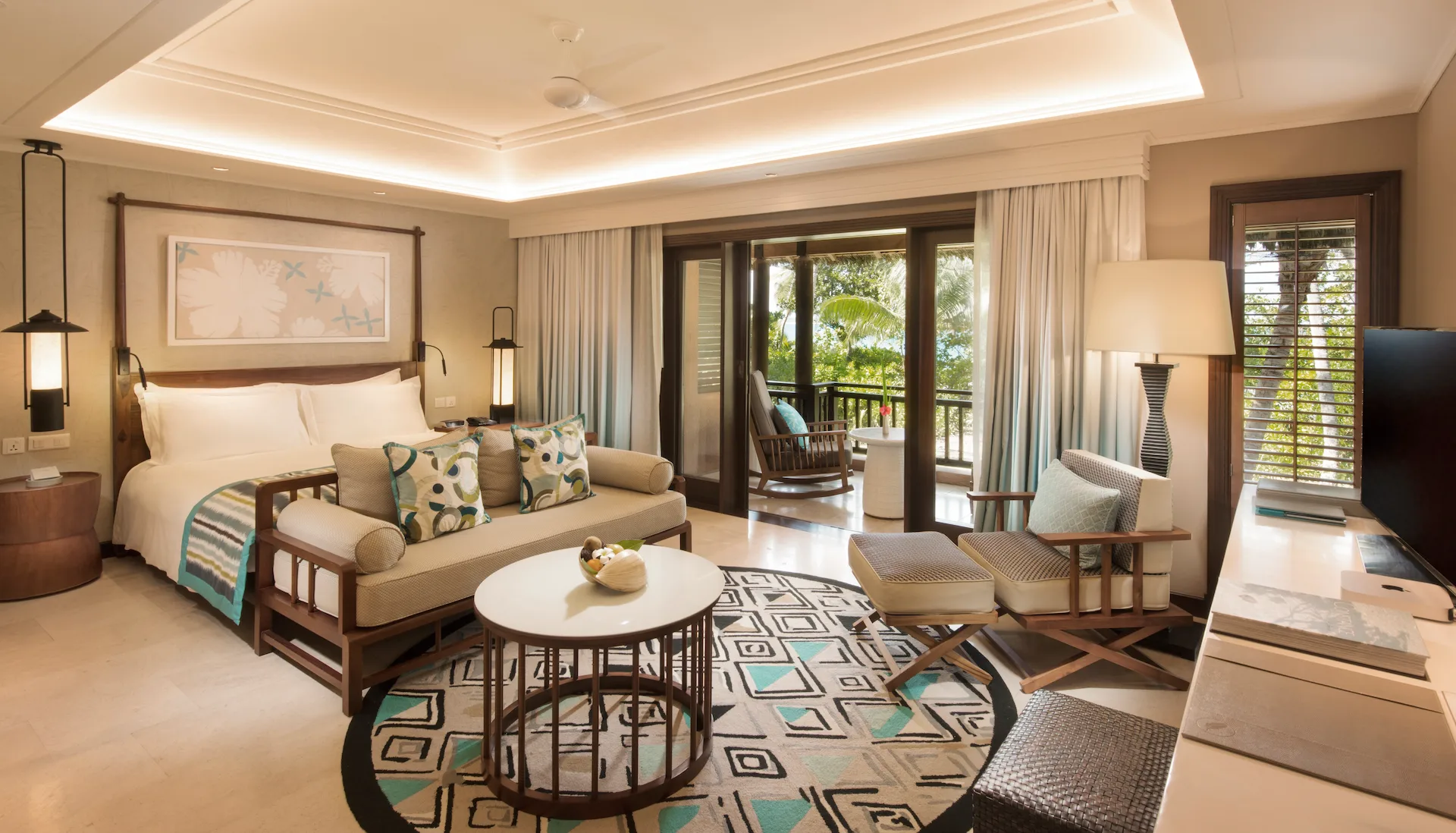 constance lemuria junior suite bedroom with king bed and tropical decor