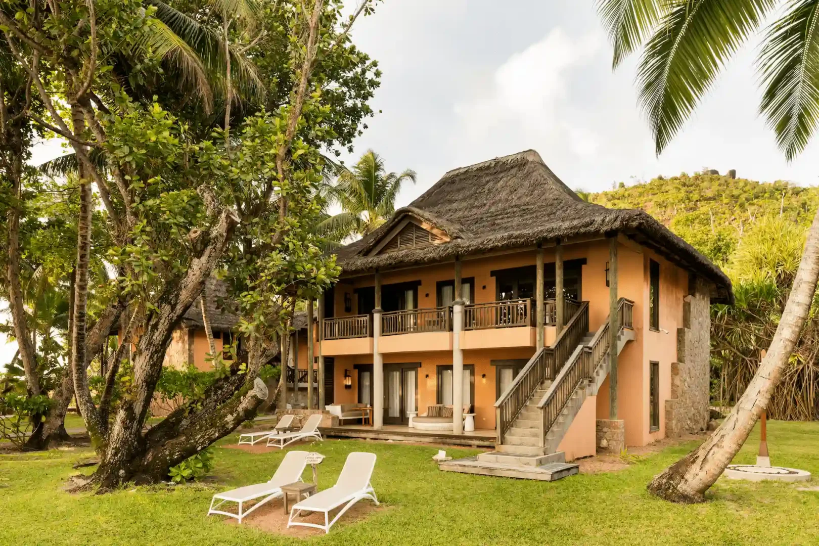 constance lemuria senior suite accommodation with spacious bedroom living area and tropical decor