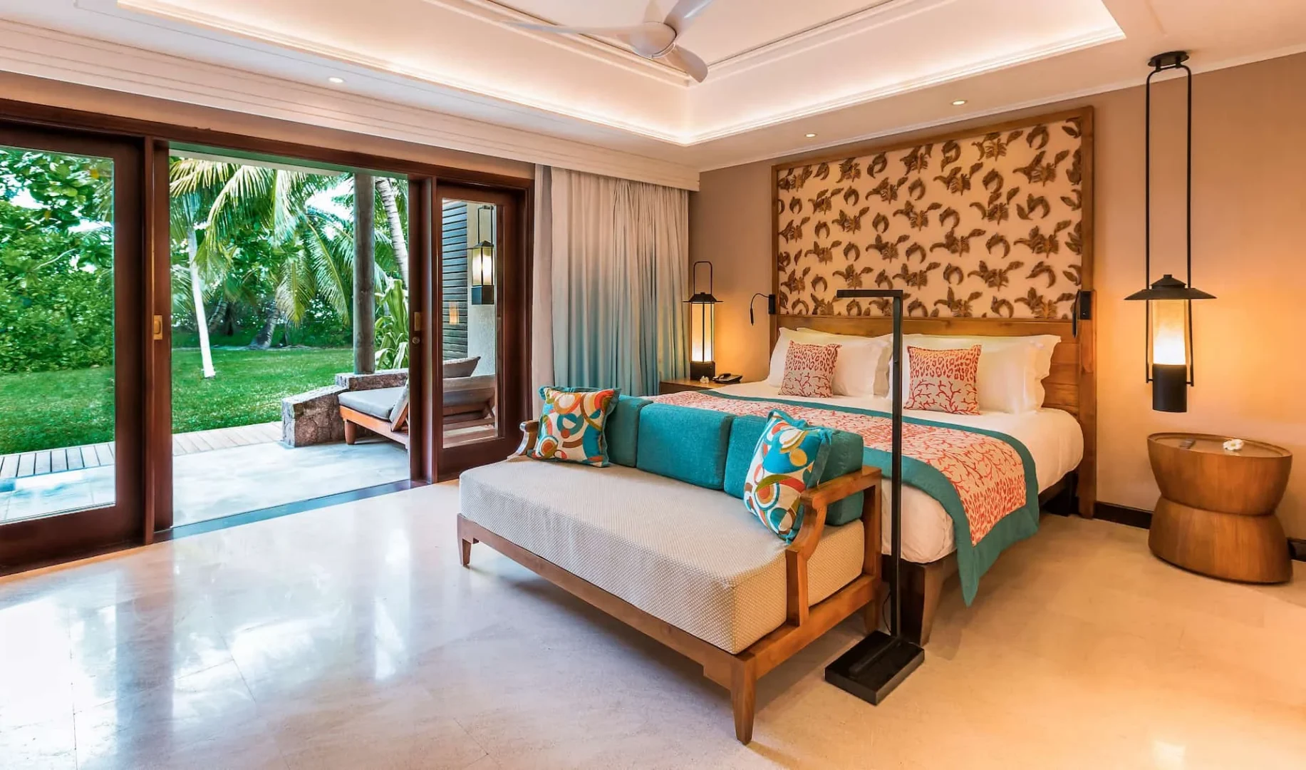 constance lemuria senior suite bed with king-size mattress and tropical-themed decor