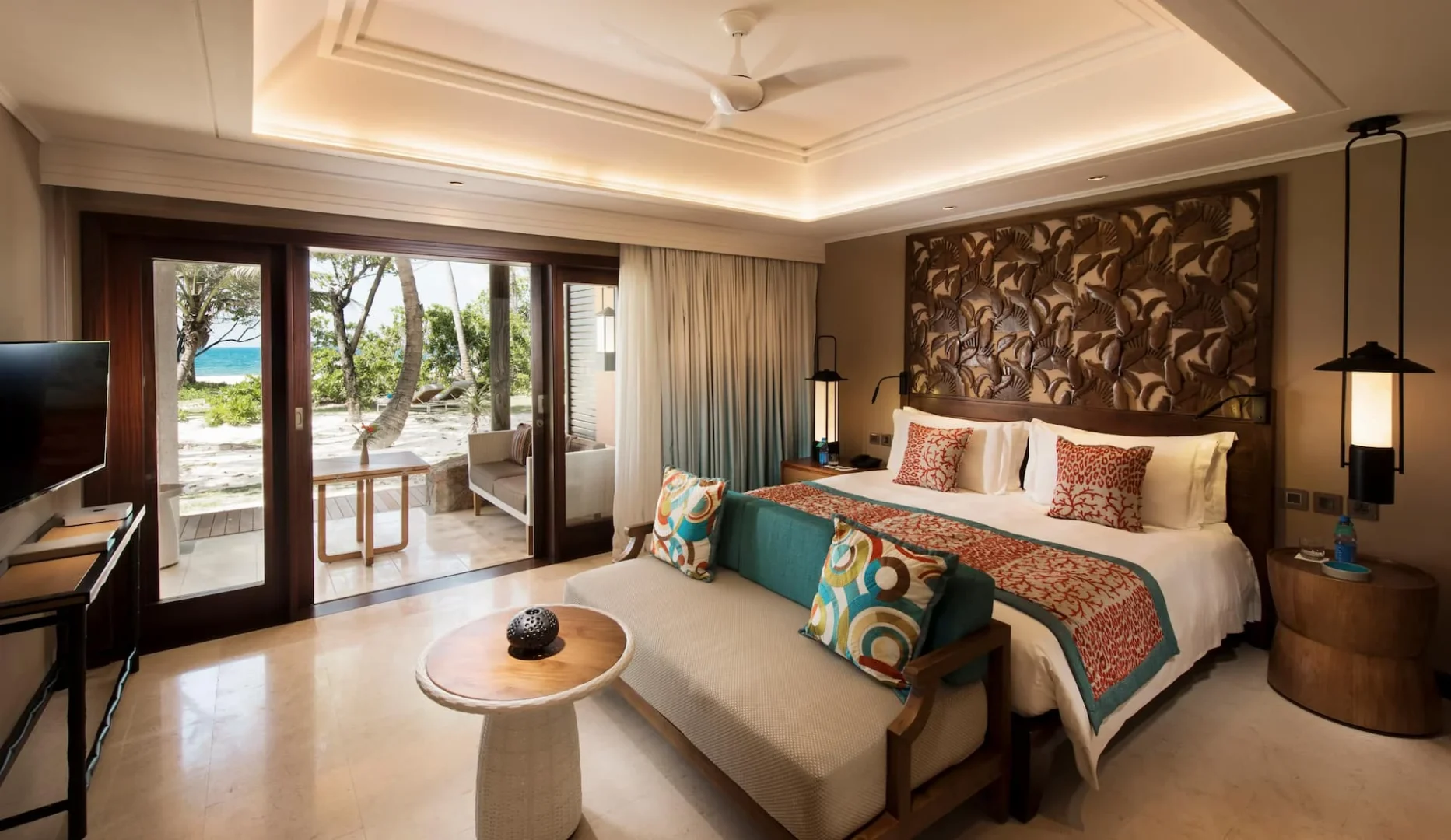 constance lemuria senior suite bedroom with king bed and elegant tropical decor