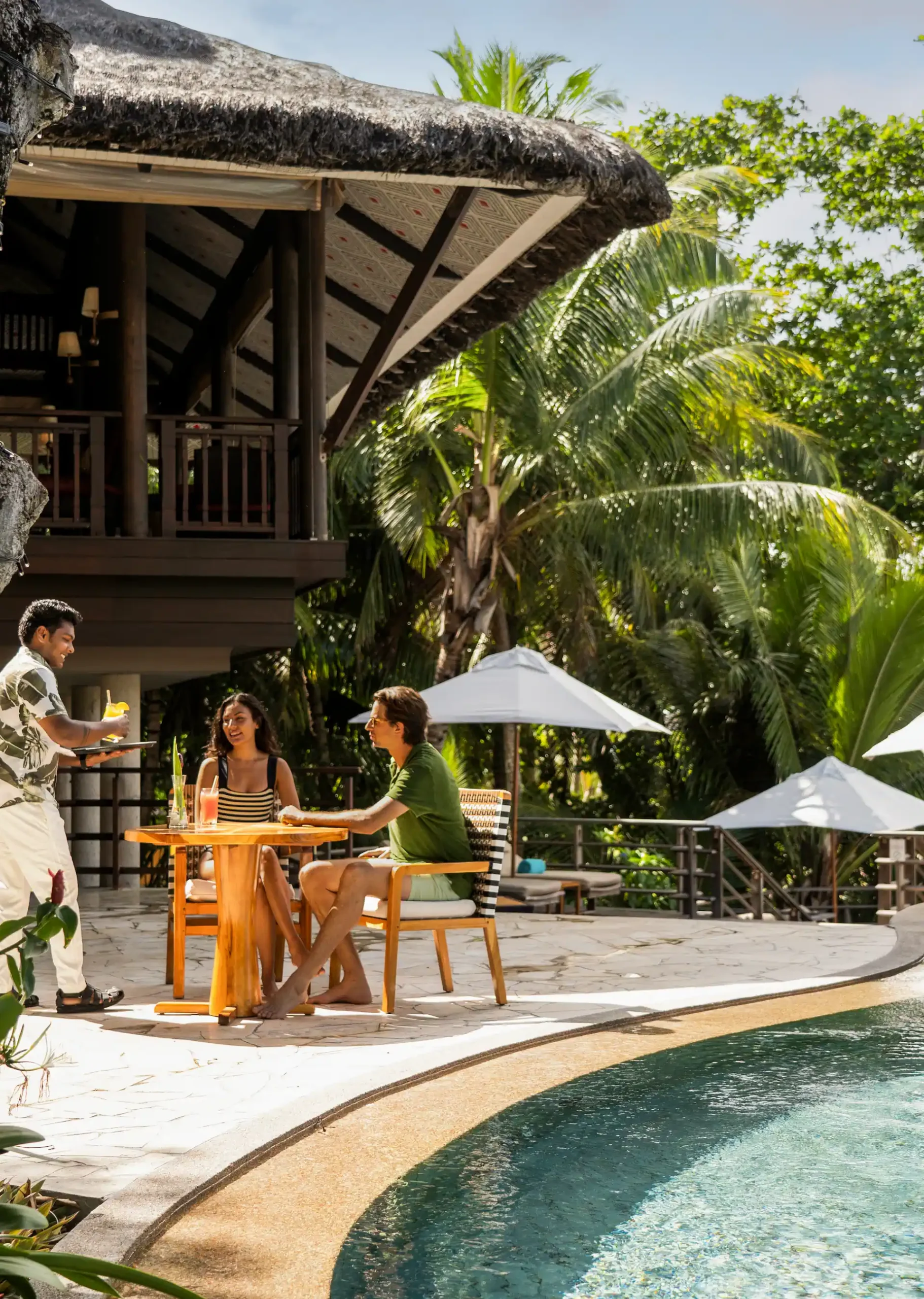 constance lemuria seychelles legend pool bar with sun loungers and ocean view