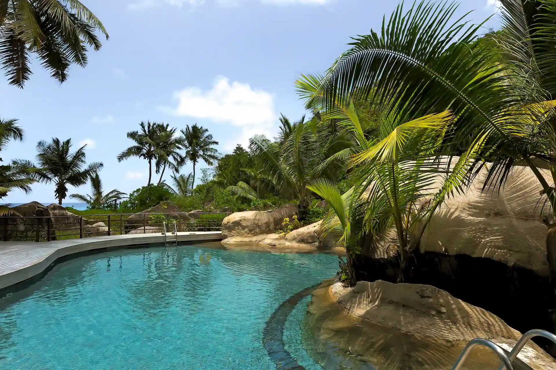 constance lemuria seychelles swimming pool with sun loungers