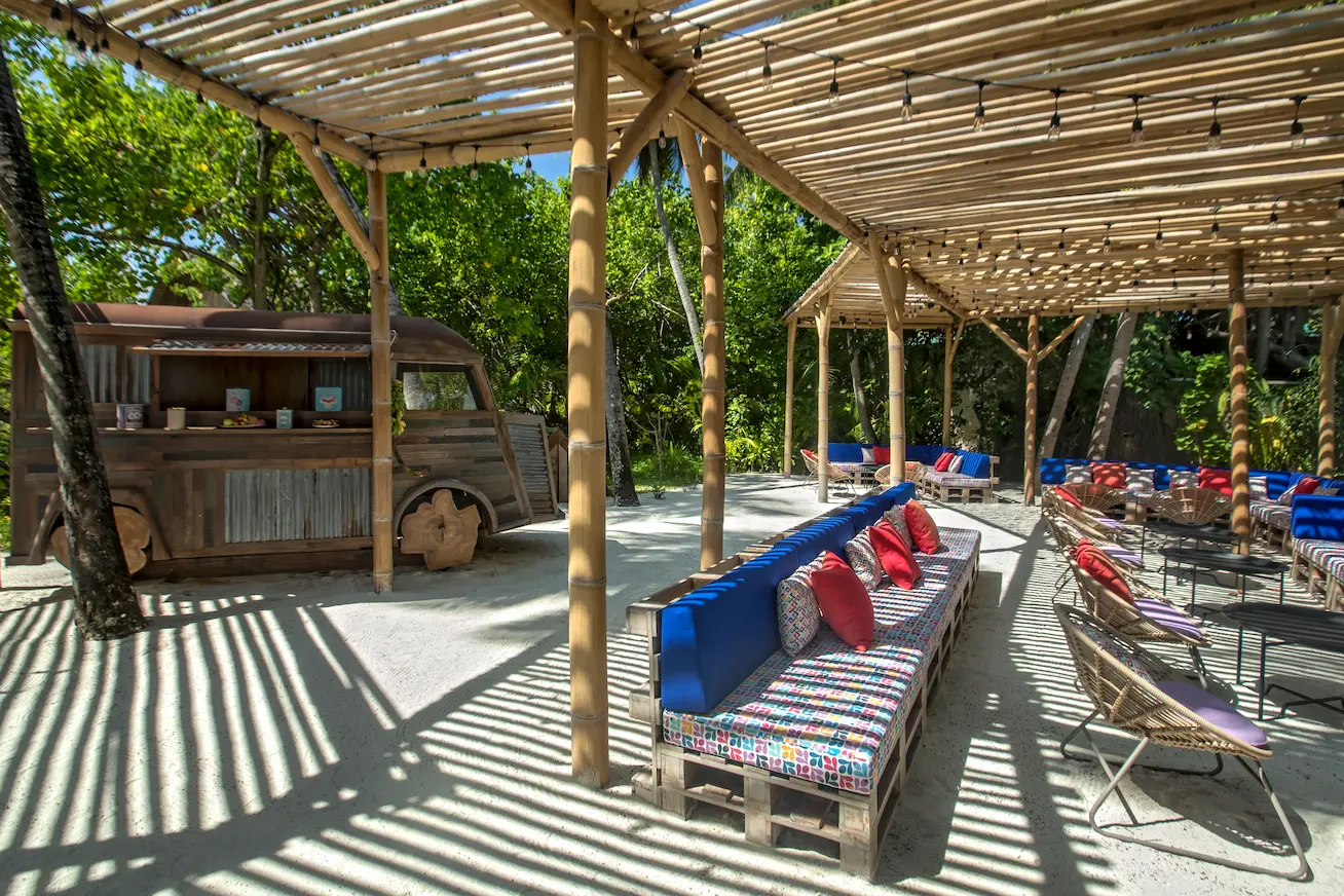 exterior view of the bar at constance moofushi maldives with relaxed beachfront ambience