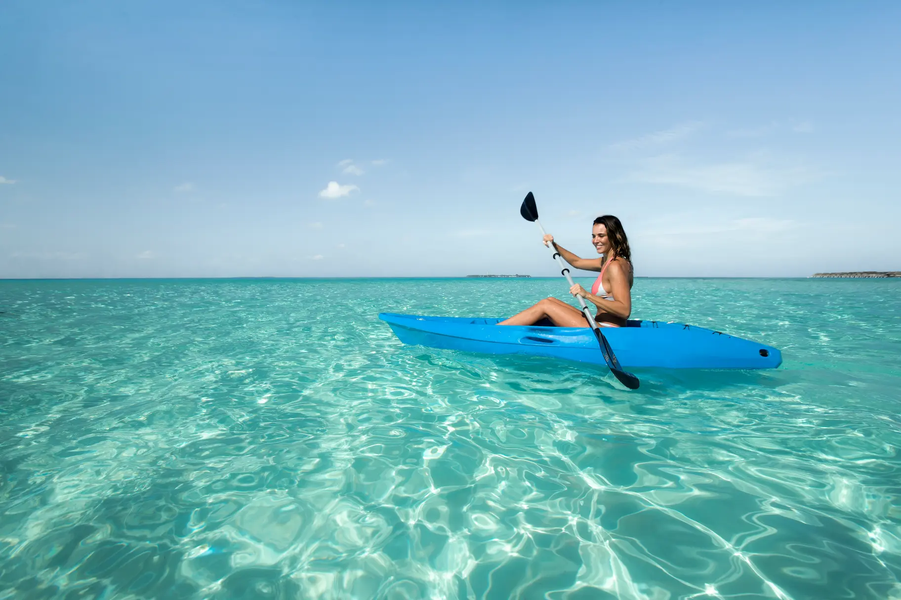 kayaking at constance moofushi maldives over clear turquoise lagoon waters