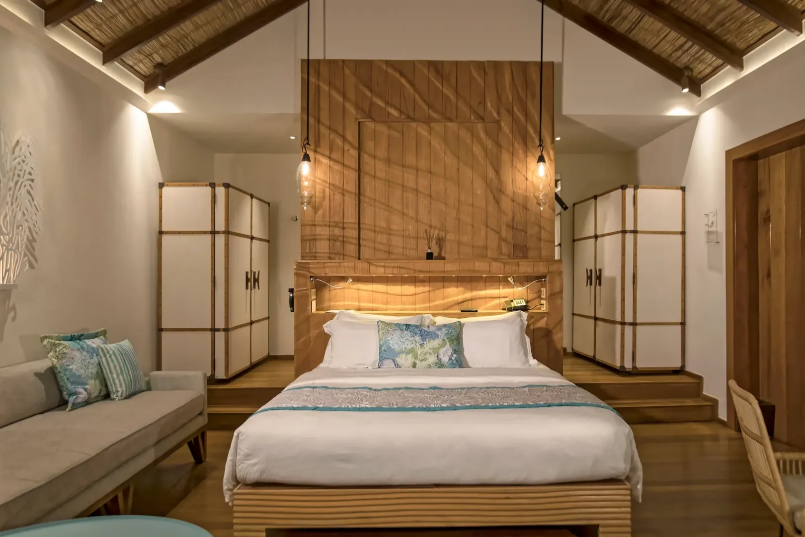 constance moofushi maldives sand villa bedroom featuring a comfortable bed in a relaxing setting