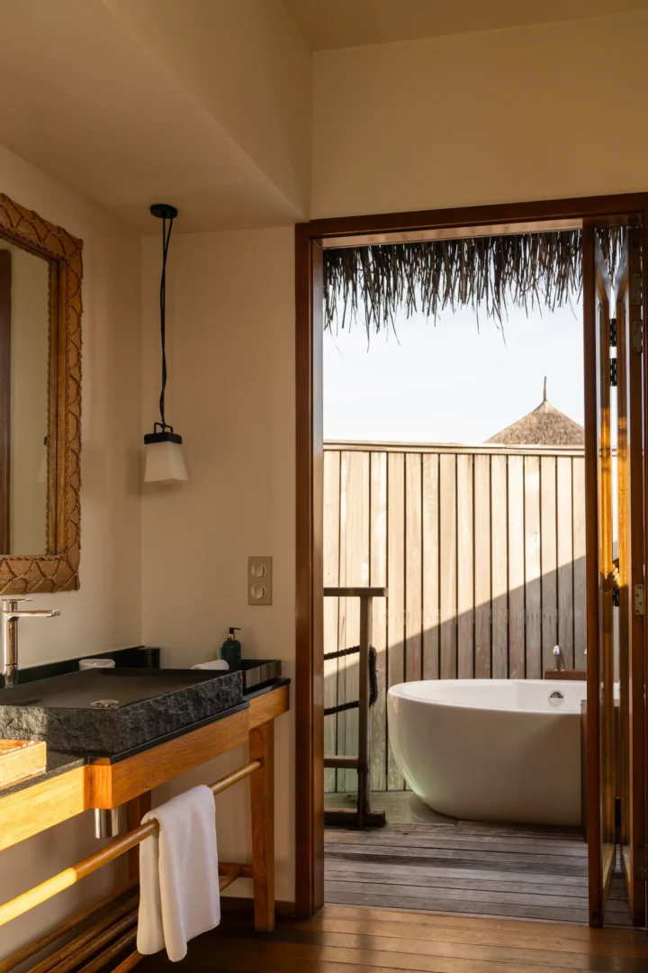 bathtub area in the senior water villa at constance moofushi maldives with calm lagoon facing design