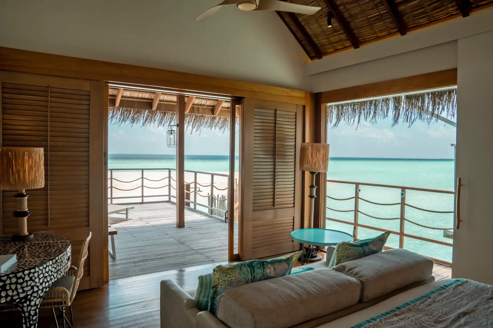 lounge area in the senior water villa at constance moofushi maldives with calm island styling