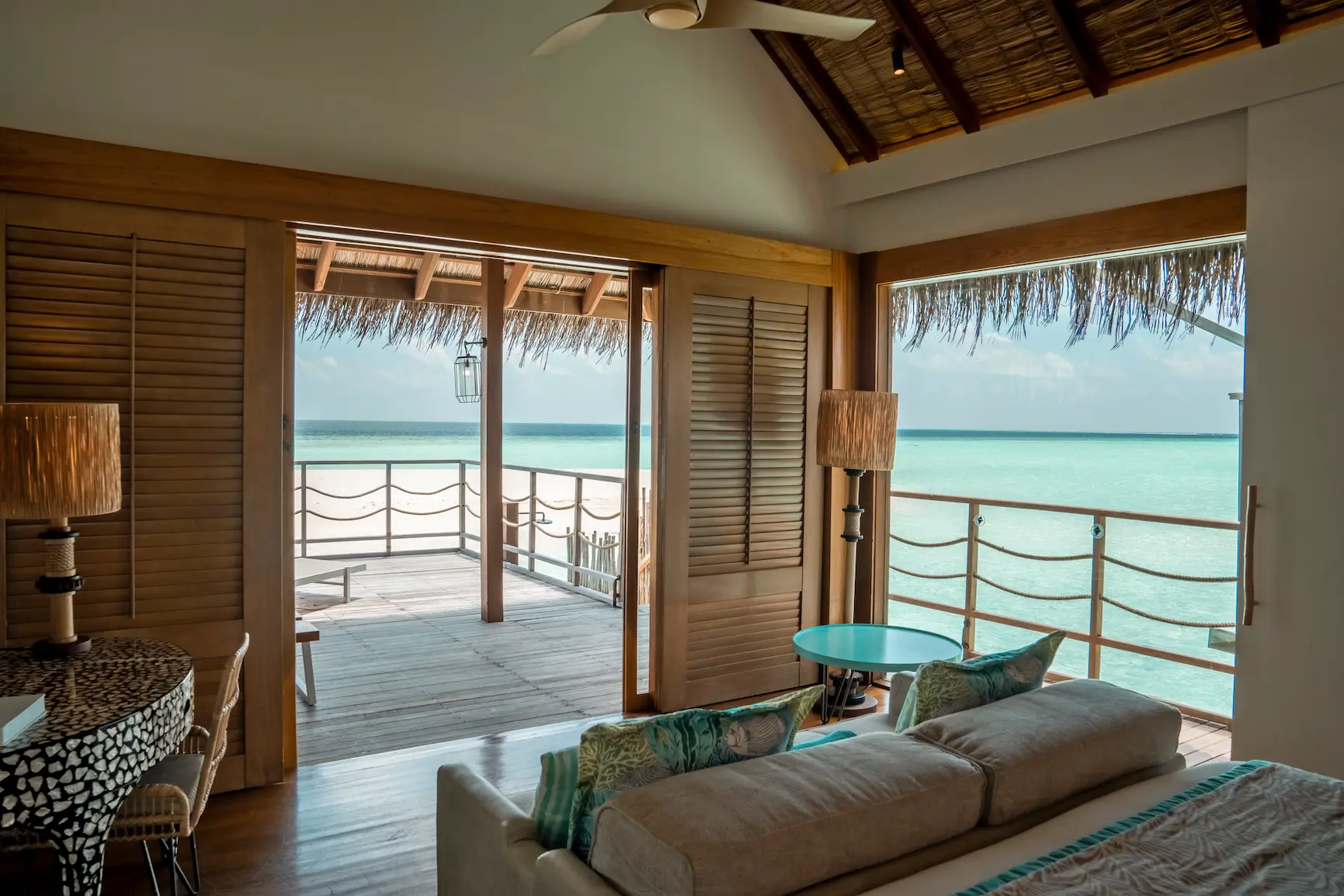 lounge area in the senior water villa at constance moofushi maldives with calm island styling