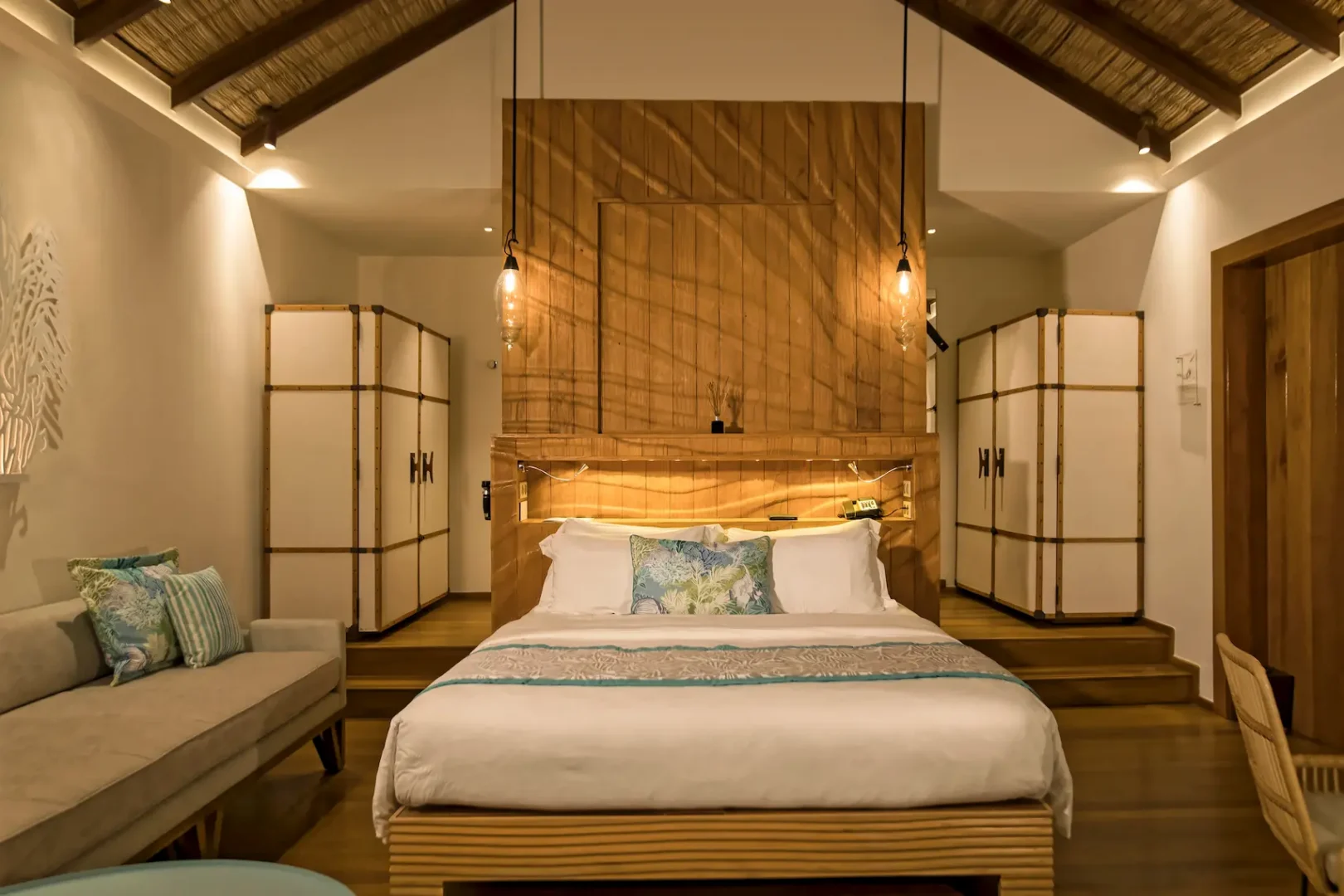 constance moofushi maldives water villa bedroom featuring a comfortable and elegant setting