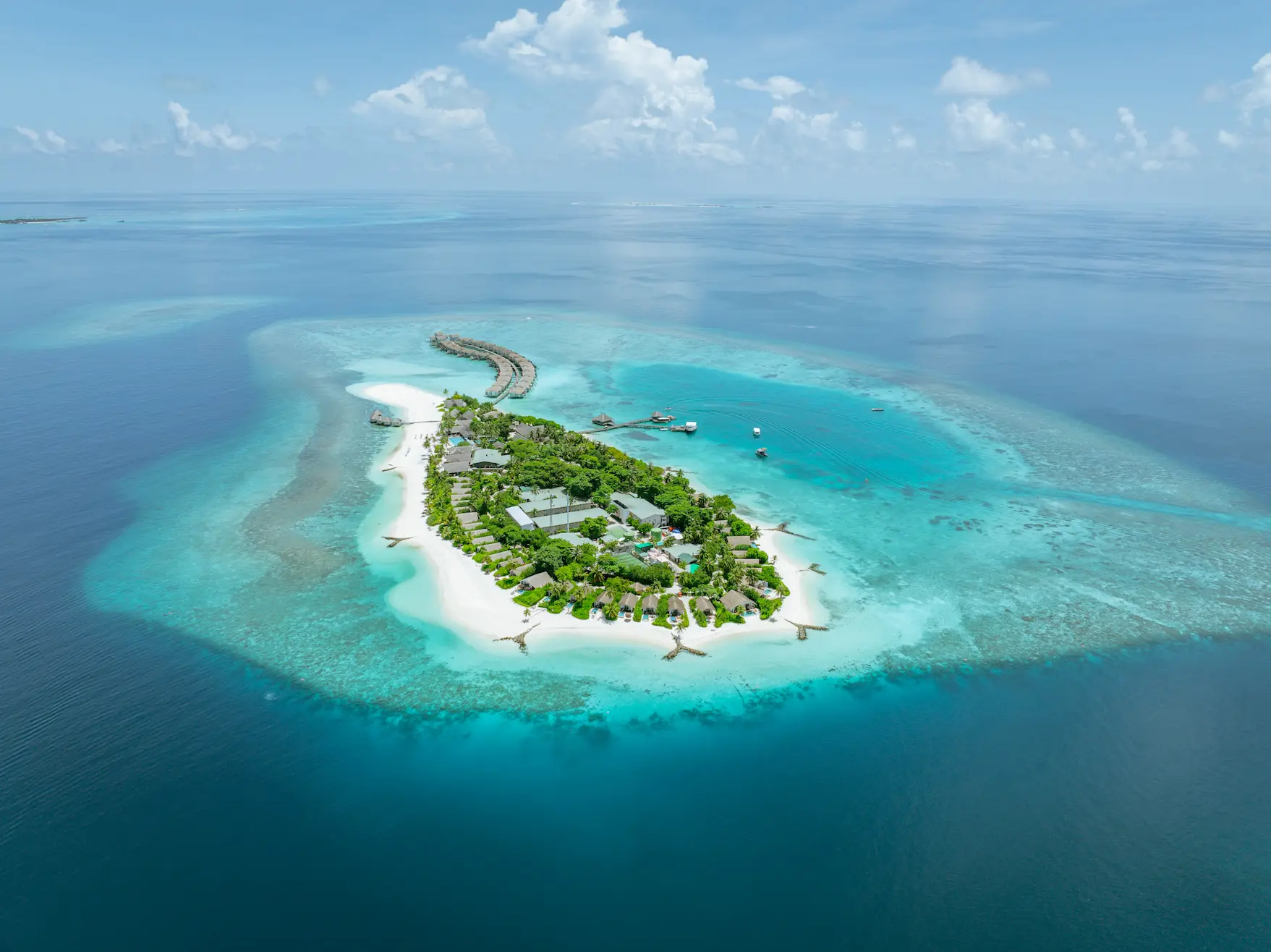 cora cora maldives aerial island view showcasing turquoise lagoon white sand beaches and serene maldives luxury setting