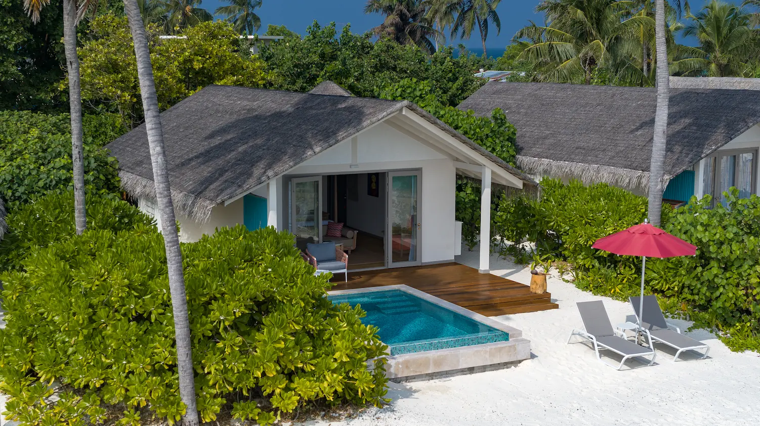 elegant exterior facade of the beach pool villa at cora cora maldives with a tranquil private pool surrounded by tropical greenery