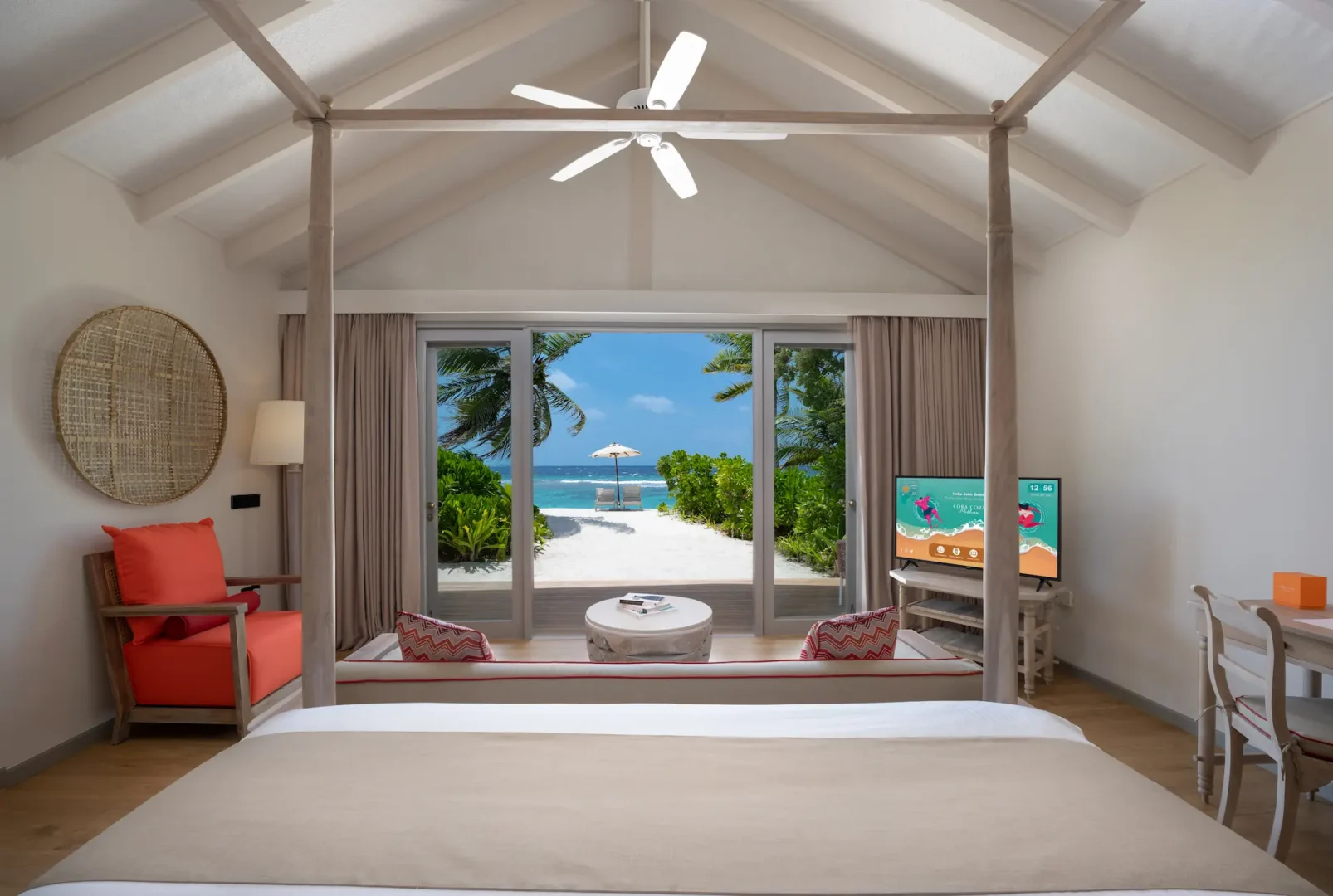serene beach villa bedroom view from the bed at cora cora maldives overlooking soft sands and tranquil turquoise water