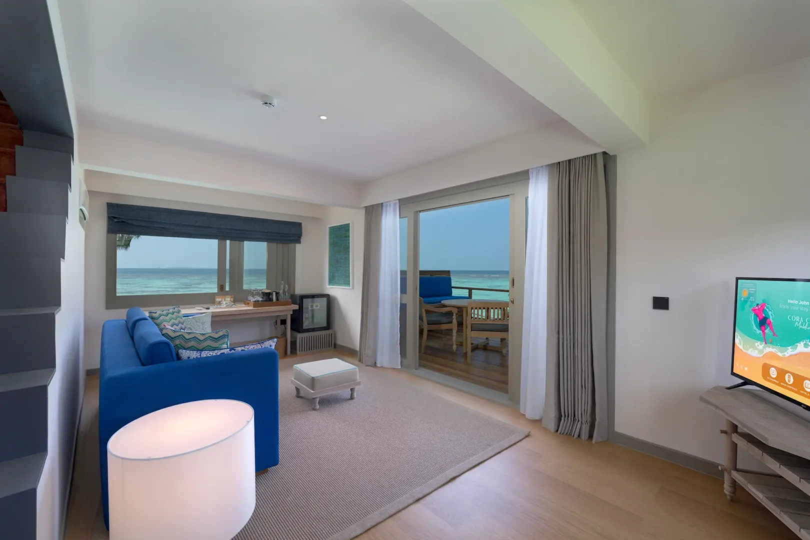 inviting downstairs living room of the duplex lagoon pool villa at cora cora maldives featuring warm natural textures and serene lagoon views