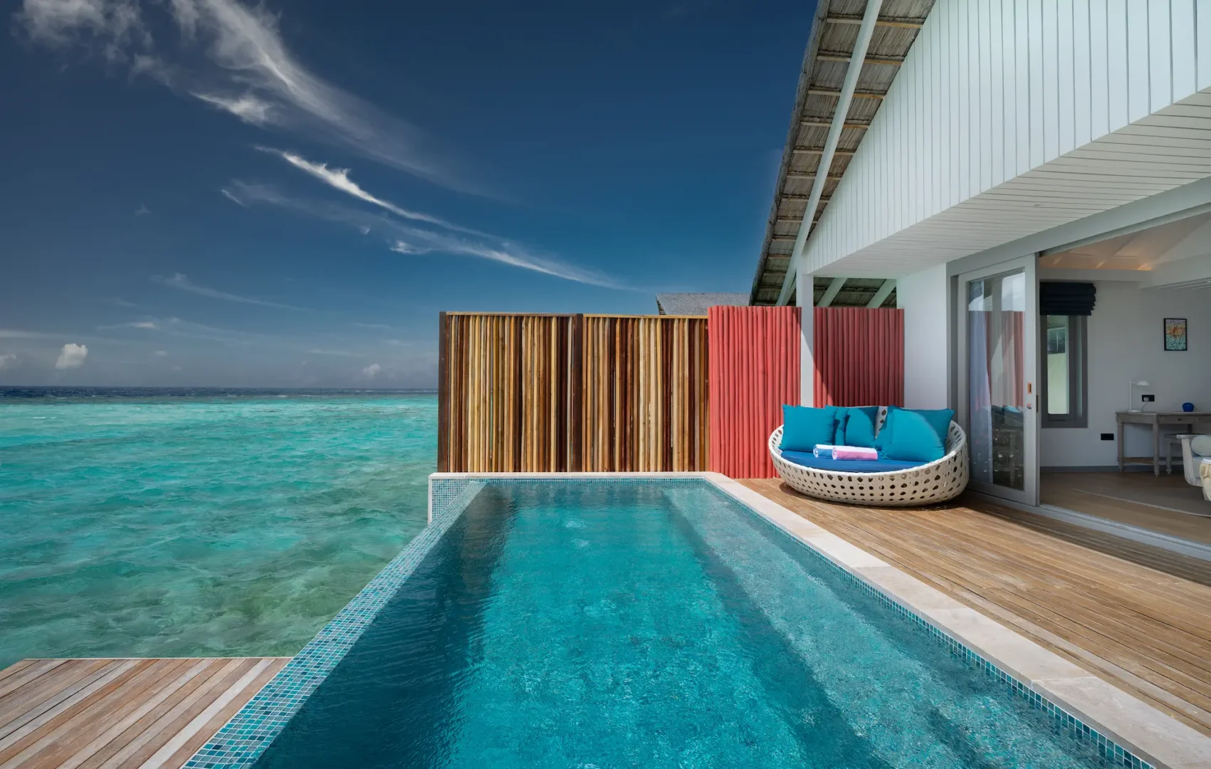 relaxing lagoon pool villa terrace at cora cora maldives featuring a sunbed beside the tranquil private pool with ocean views