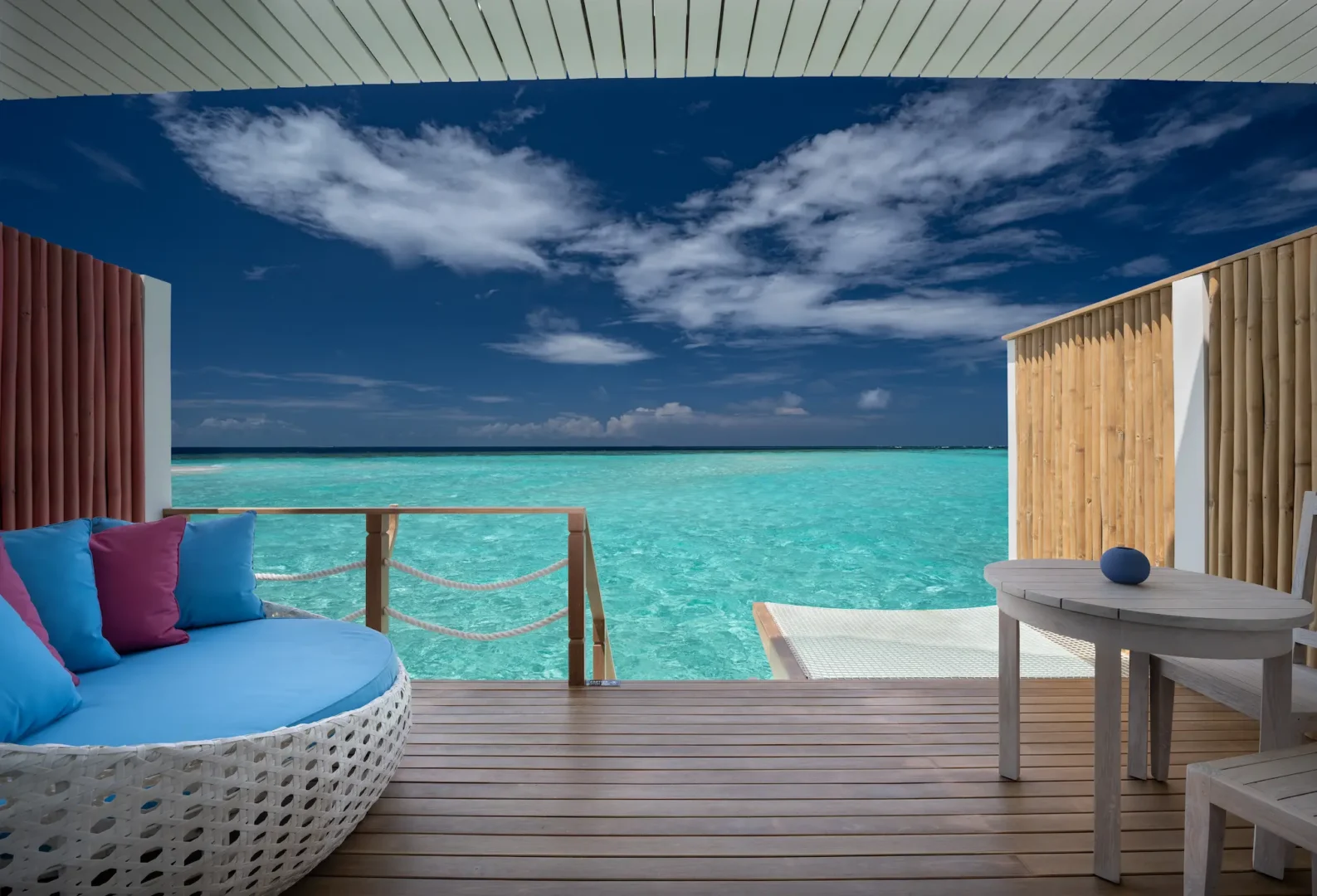 spacious lagoon villa terrace at cora cora maldives overlooking calm turquoise waters with serene outdoor seating