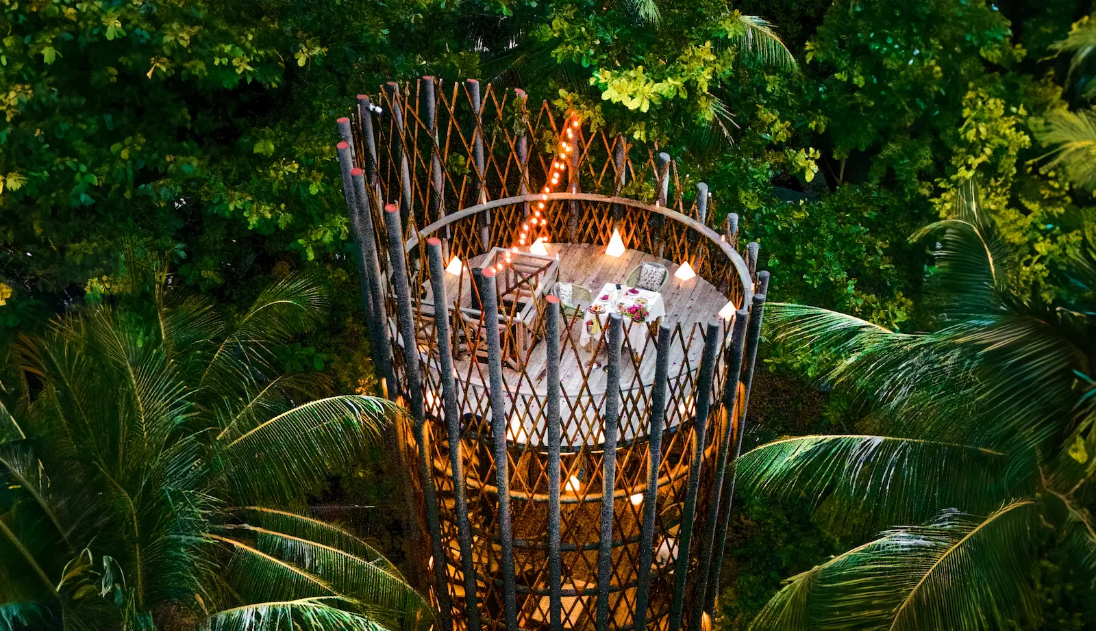 cora cora maldives stargazing dinner aerial view showcasing romantic beach setup candlelit ambiance and clear maldives night sky