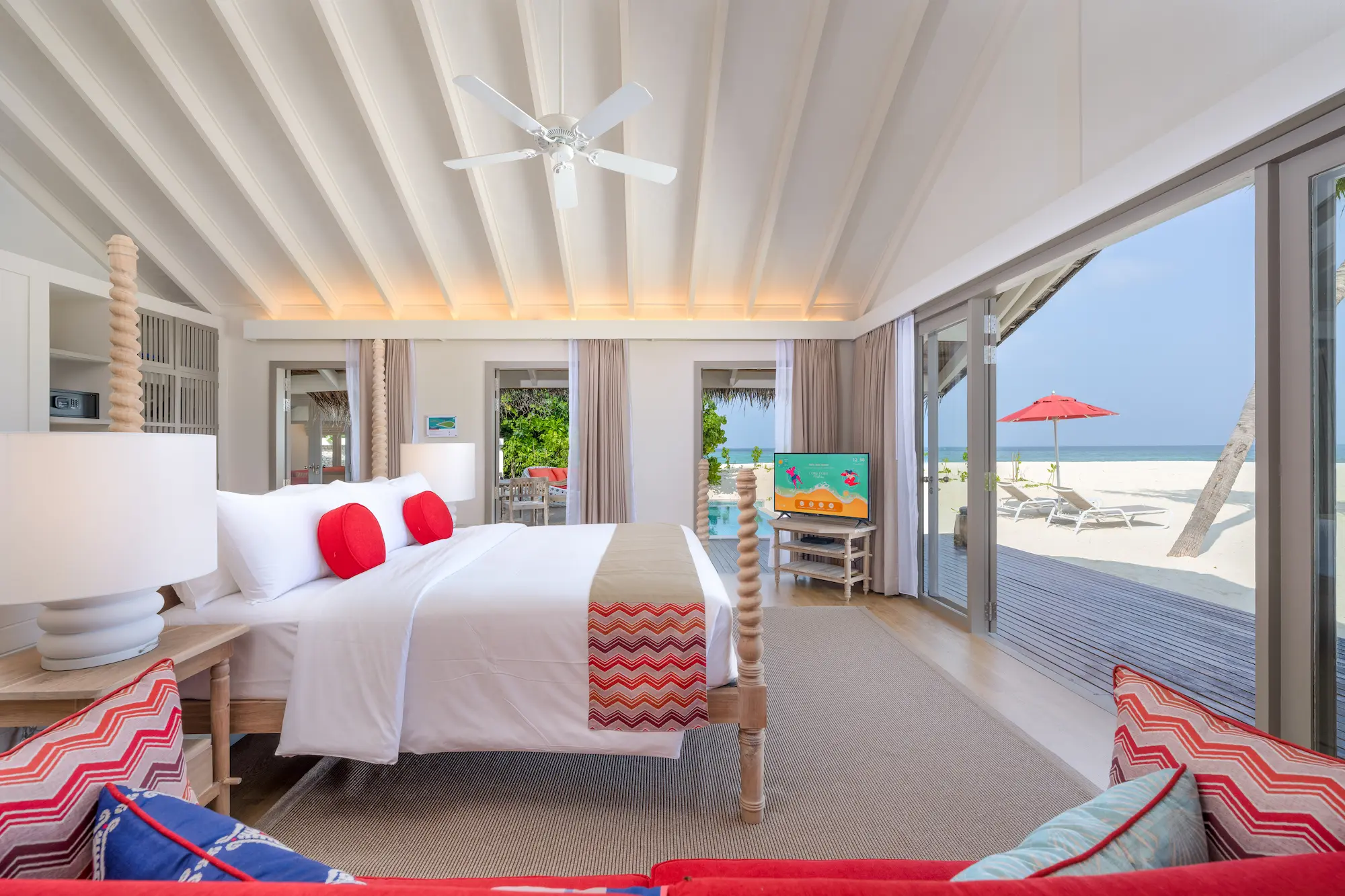 master bedroom of the two bedroom beach pool suite at cora cora maldives with a serene view of the beach and soft natural lighting