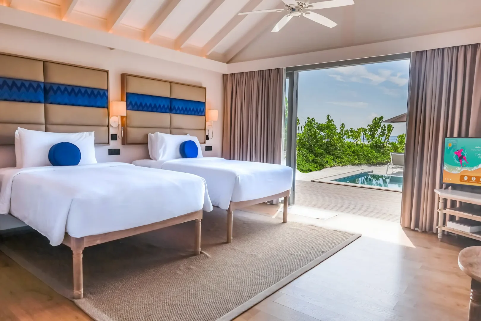 twin bedroom of the two bedroom beach pool suite at cora cora maldives with a serene view and soft natural lighting