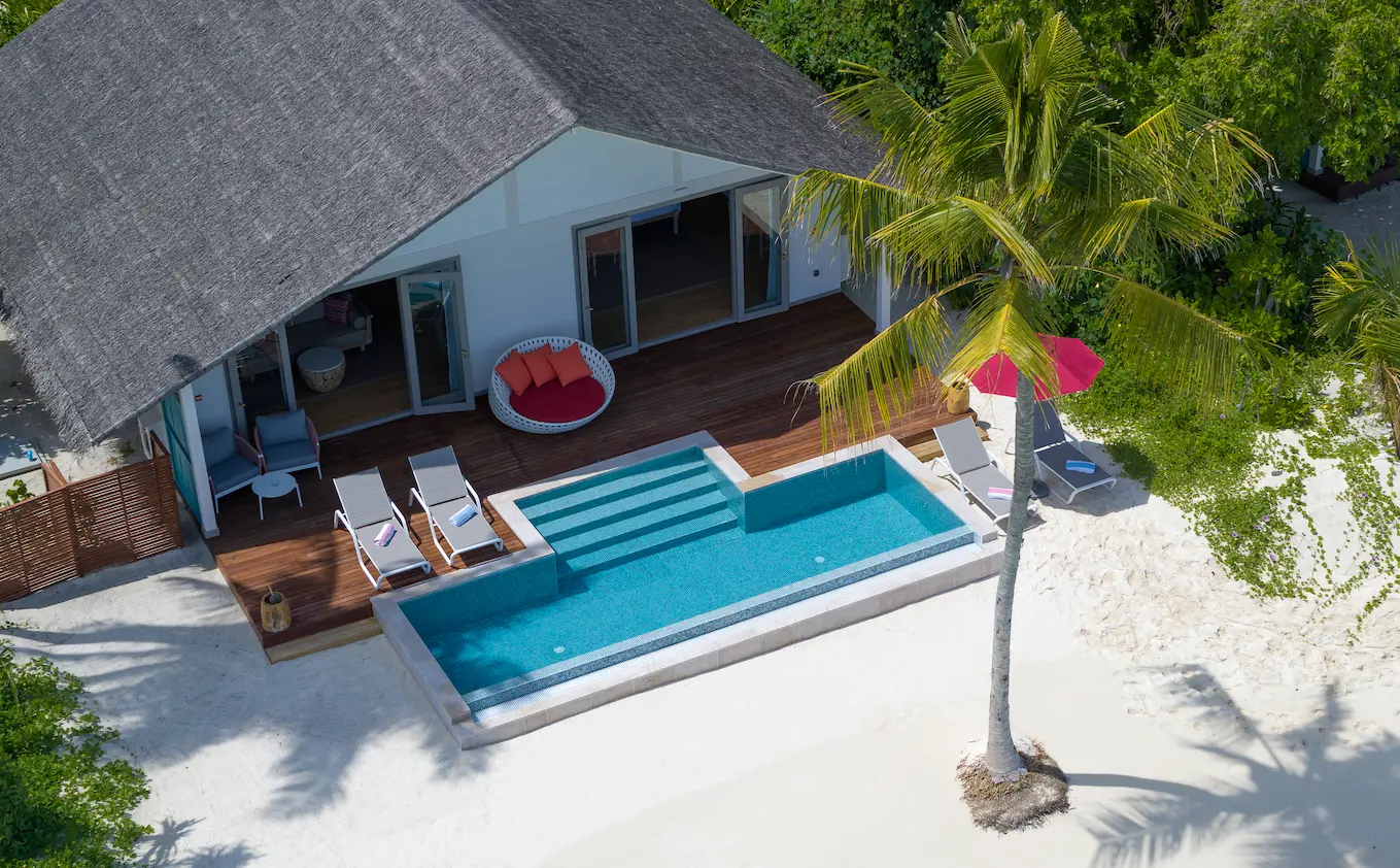 aerial view of the facade of the two bedroom family beach pool villa at cora cora maldives showcasing its tropical surroundings and tranquil coastal setting