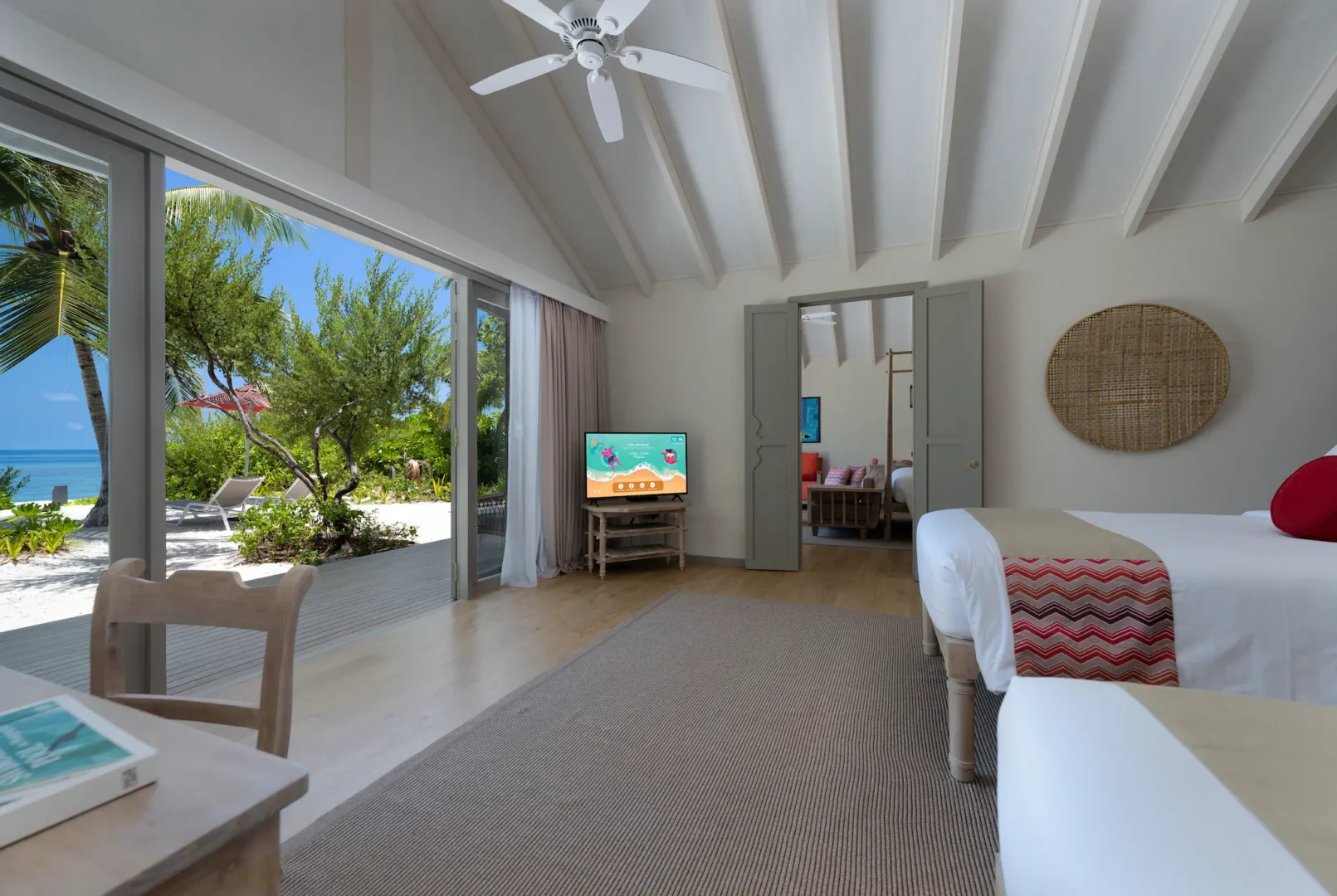 interconnecting twin bedroom in the two bedroom family beach villa at cora cora maldives featuring soft natural tones and a relaxed family‑friendly atmosphere