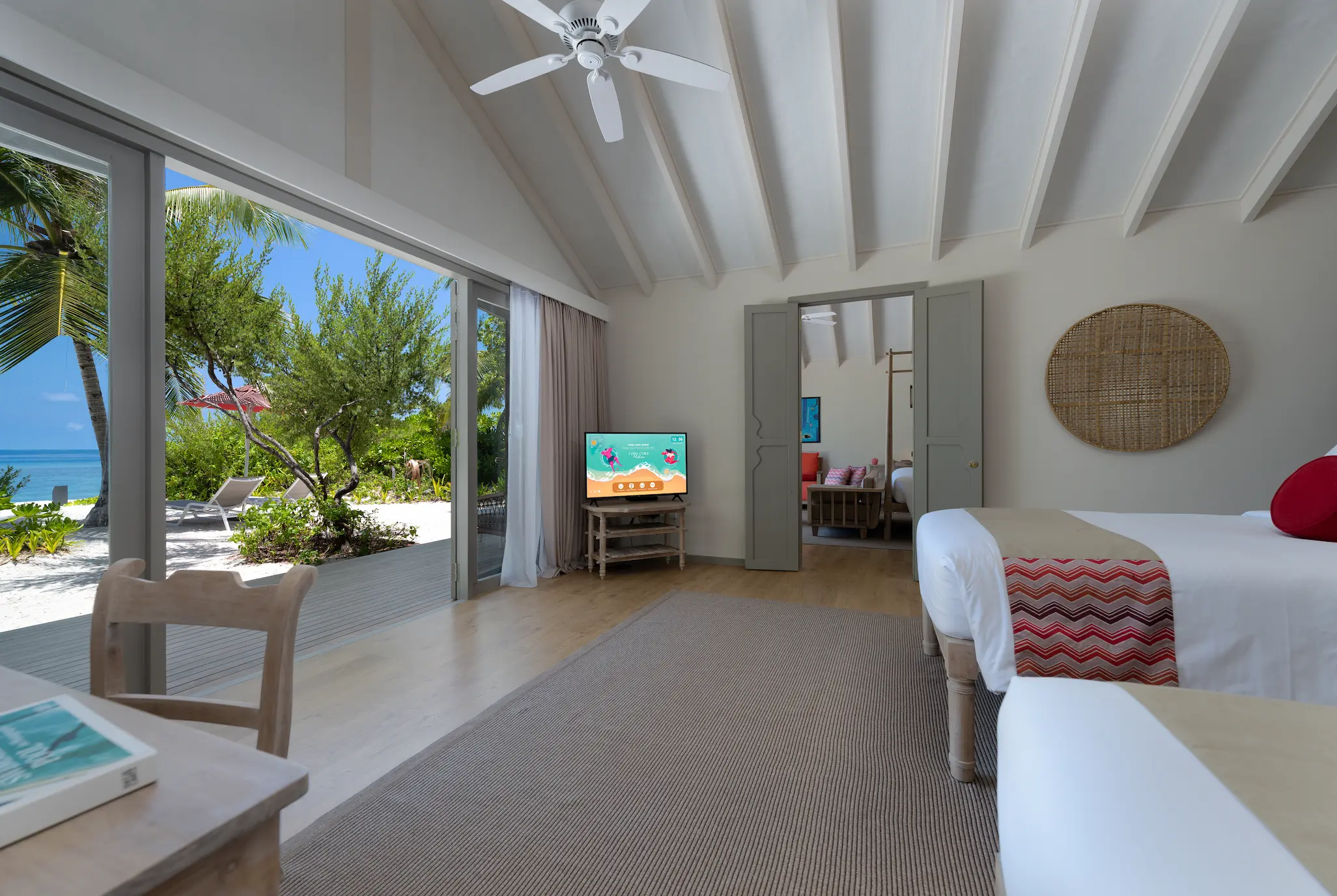 interconnecting twin bedroom in the two bedroom family beach villa at cora cora maldives featuring soft natural tones and a relaxed family‑friendly atmosphere
