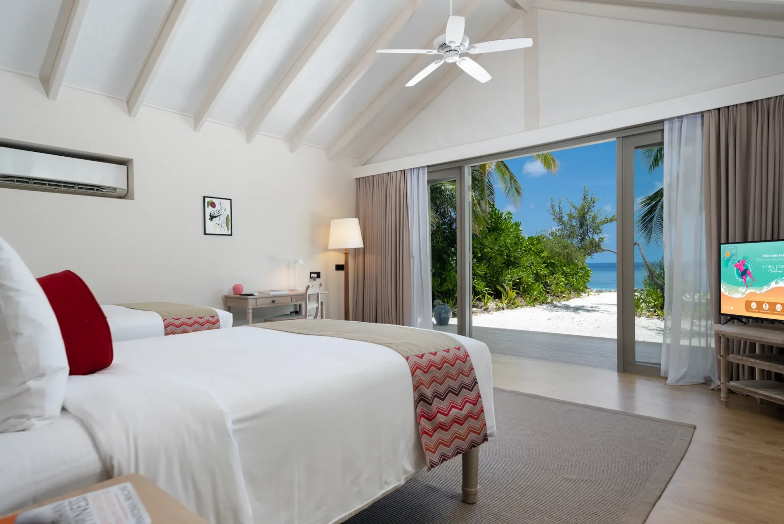 twin bedroom of the two bedroom family beach villa at cora cora maldives with a serene view and soft natural lighting