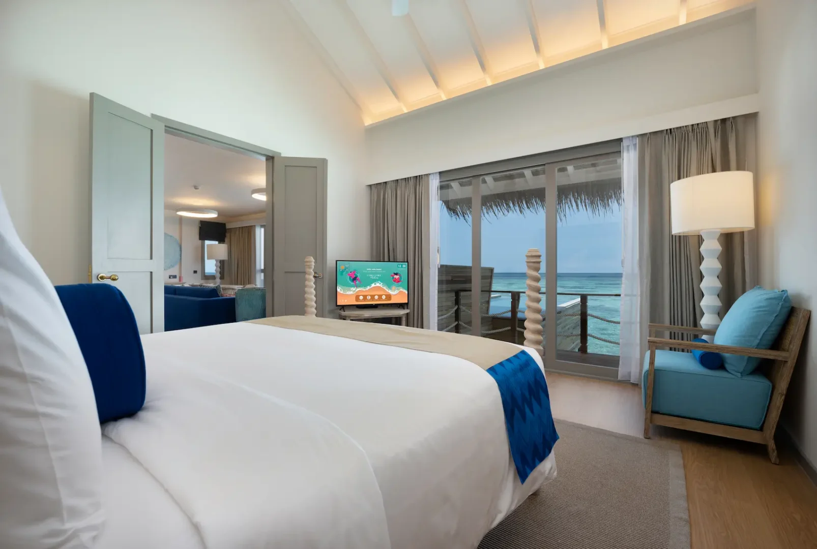 cora cora maldives two bedroom lagoon pool villa with slide master bedroom featuring serene overwater luxury design and panoramic lagoon views