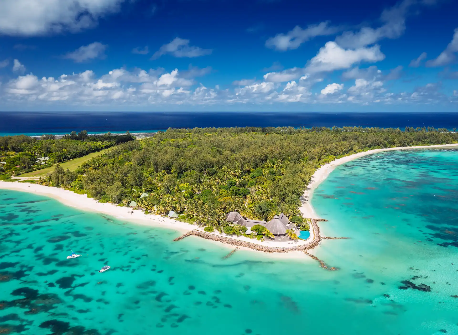 denis private island seychelles aerial side view showing white sand beaches, turquoise lagoon, and surrounding tropical vegetation