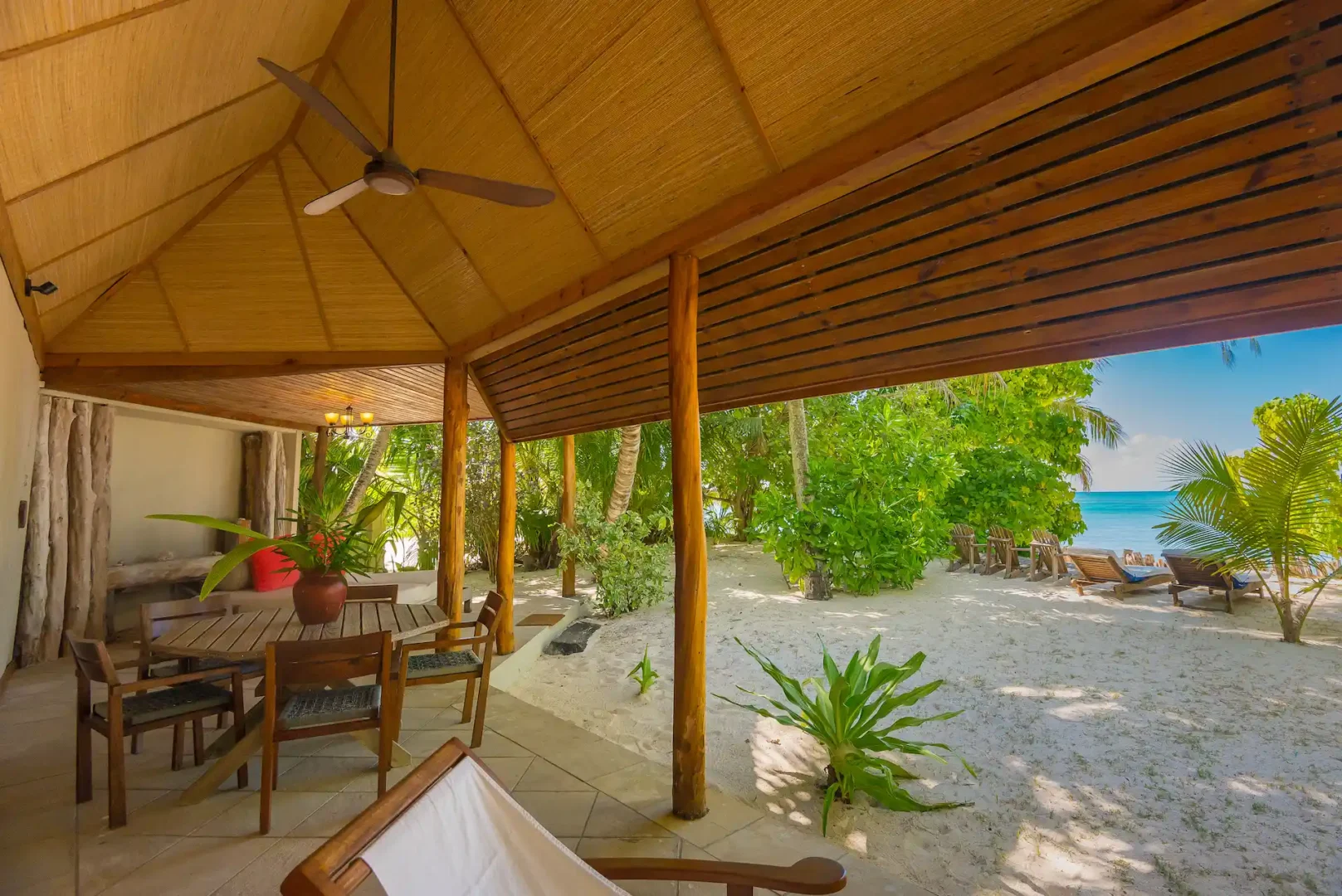 denis private island seychelles beach cottage terrace with outdoor seating, tropical garden views, and direct path to the white sand beach