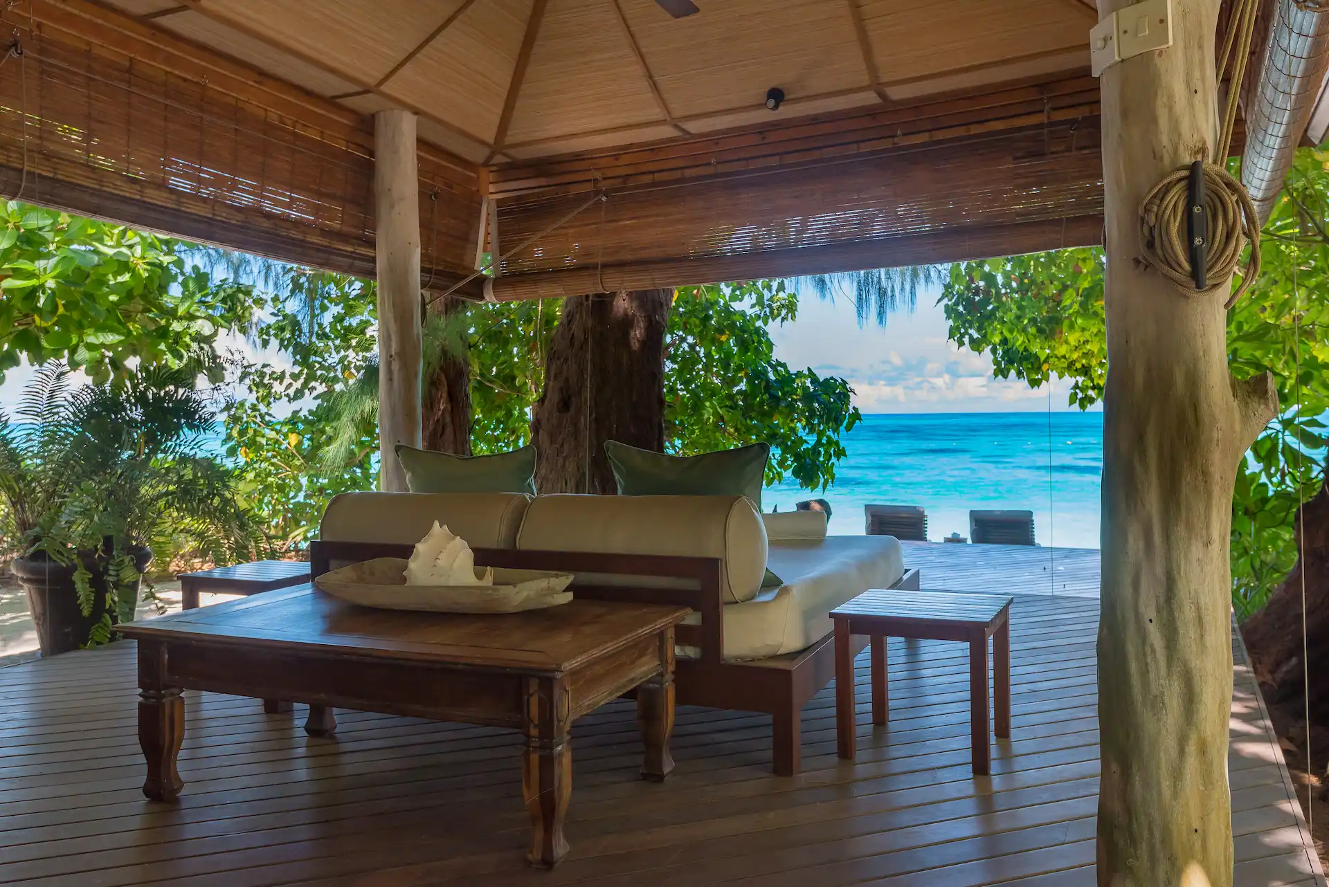 denis private island seychelles beach villa decking with sun loungers, private terrace, and panoramic views of the turquoise ocean and white sand beach