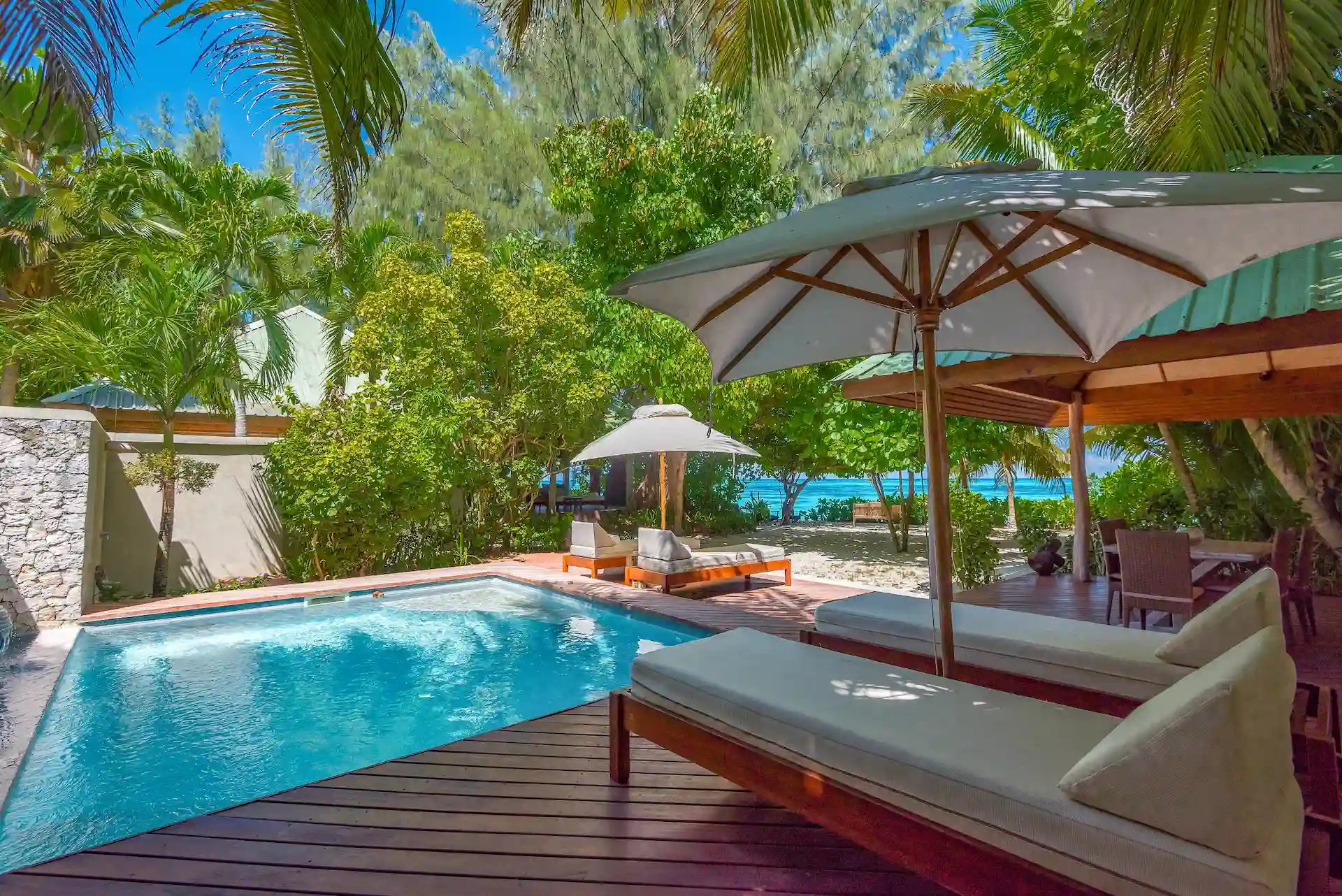 denis private island seychelles beach villa with private infinity pool, sun loungers, and panoramic views of the turquoise ocean and surrounding tropical gardens