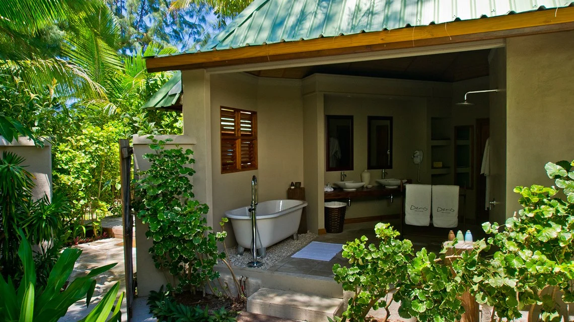 denis private island seychelles beach cottage bathroom with modern fixtures, spacious layout, and tropical garden or beach views
