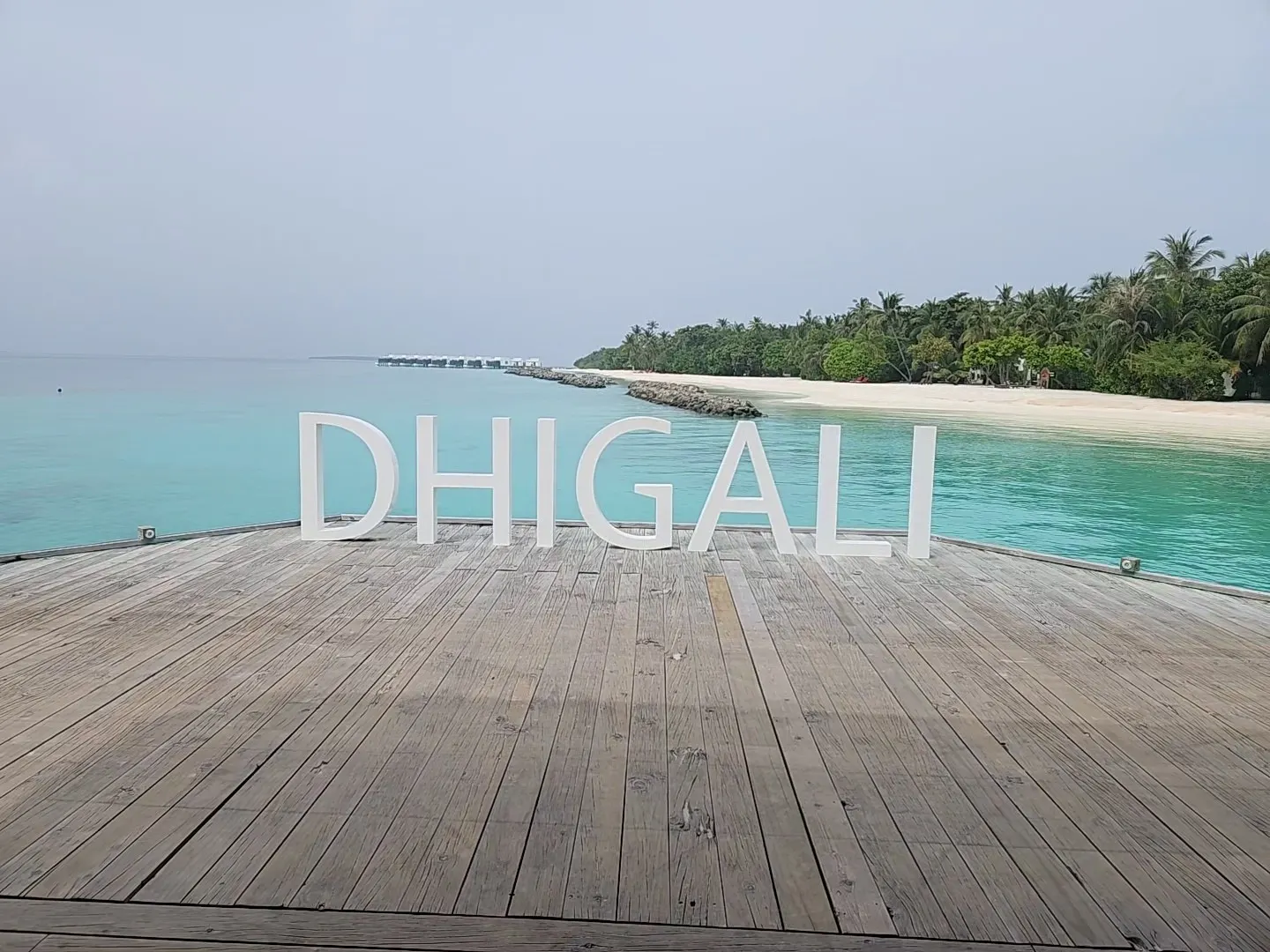 dhighali island maldives wooden beach sign