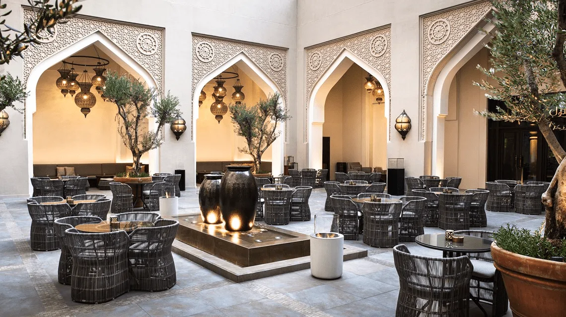 the courtyard at Manzil Downtown featuring outdoor seating with modern arabesque design elements and a relaxed ambiance in downtown dubai