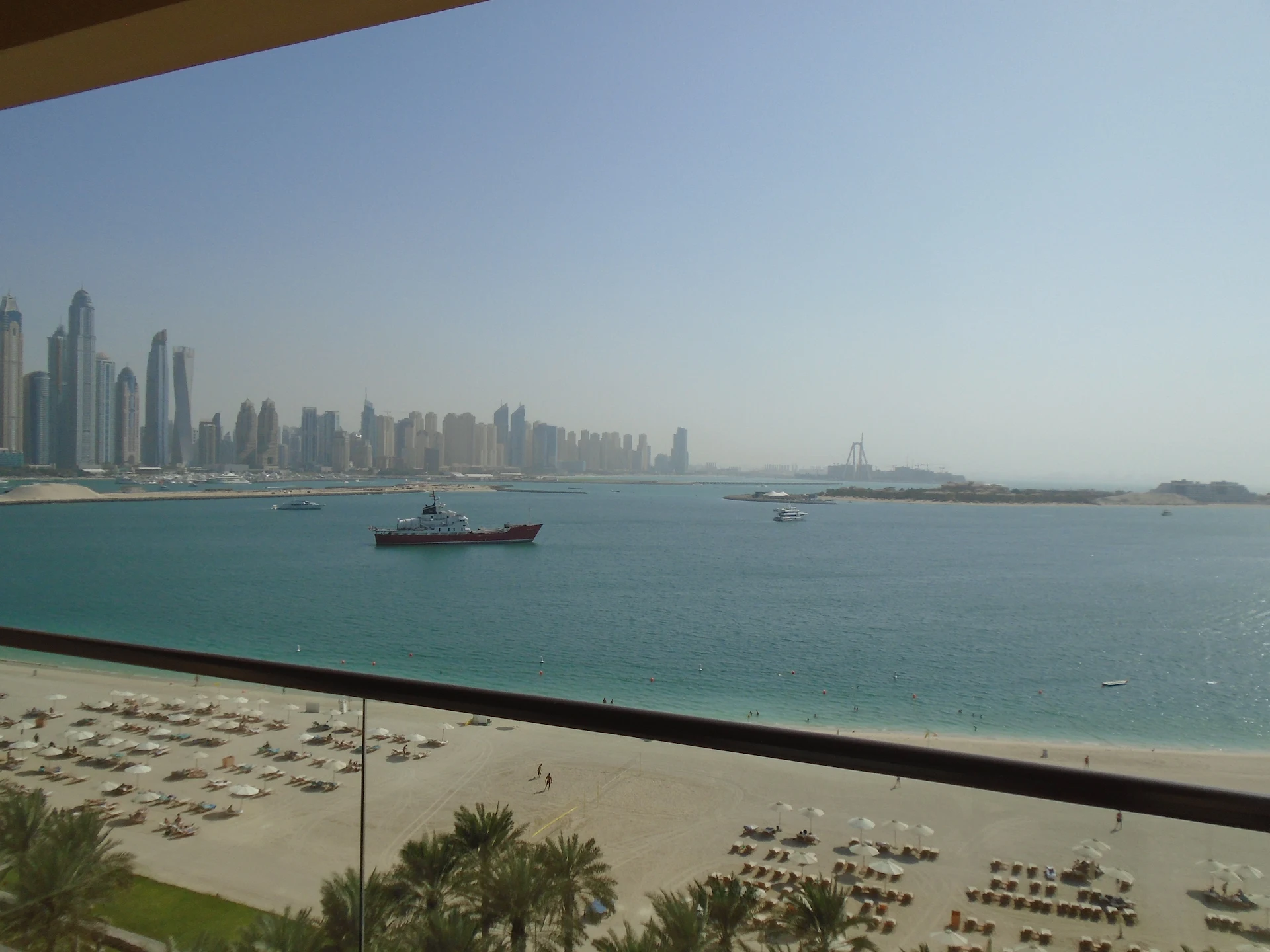dubai city skyline viewed from a balcony with modern skyscrapers and streets below in daylight