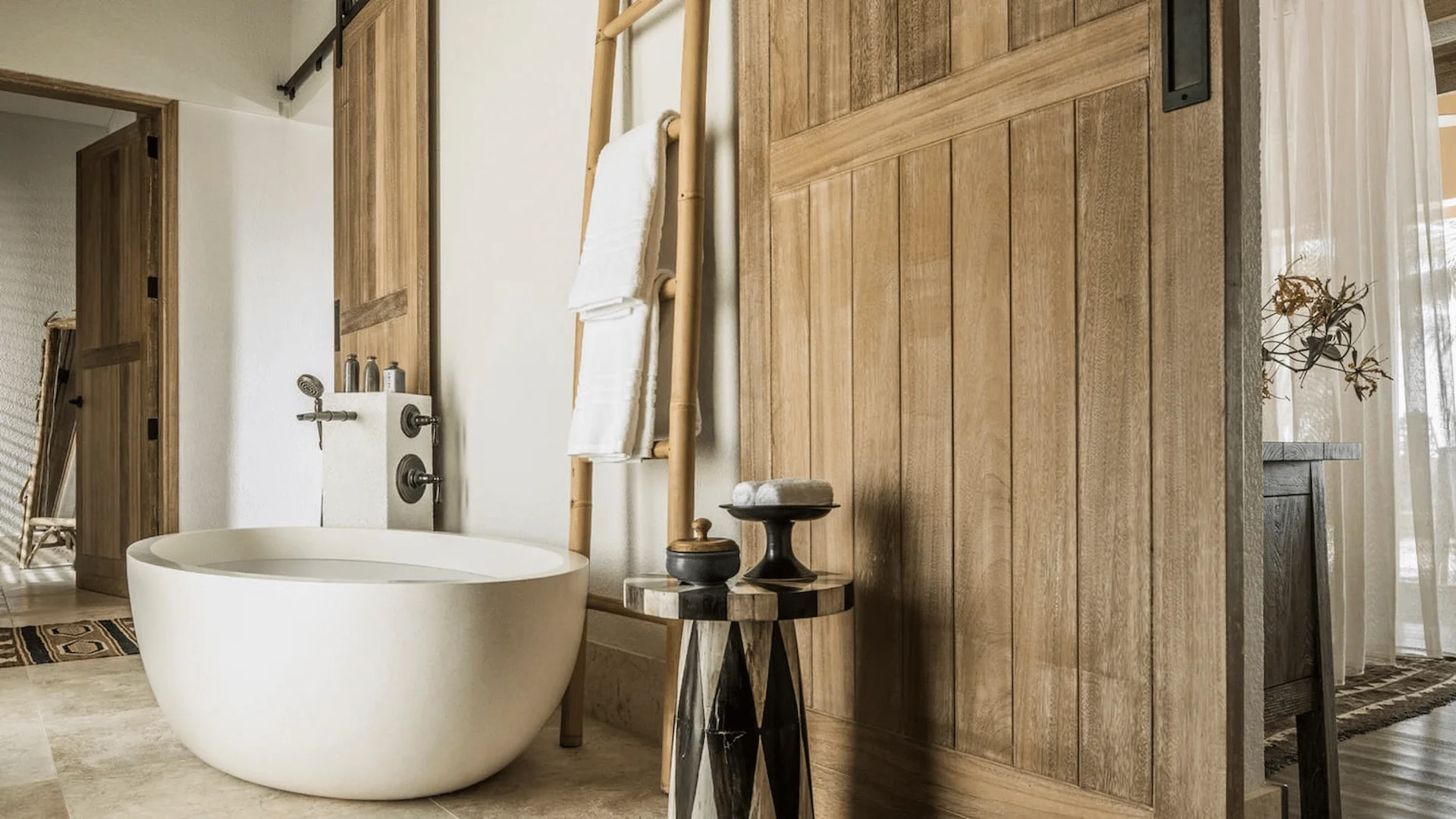 bathroom in a two bedroom sunset beach suite at four seasons resort desroches seychelles with bathtub and modern fittings