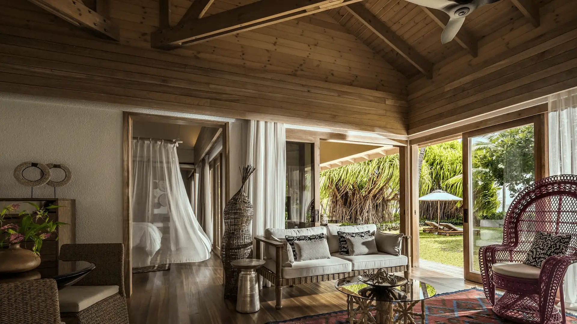 lounge area in a two bedroom sunset beach suite at four seasons resort desroches seychelles with comfortable seating and open space
