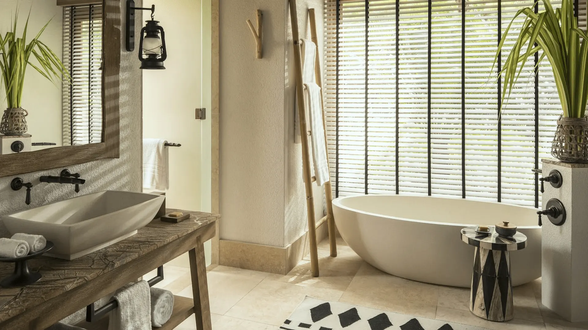 bathroom in a pool villa at four seasons resort desroches seychelles with sunset light and views through windows