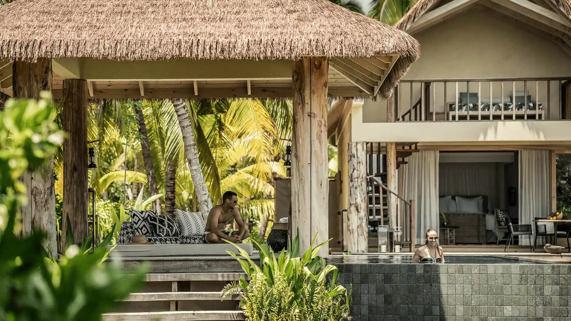 exterior of a pool villa at four seasons resort desroches seychelles during sunset with ocean and sky views"