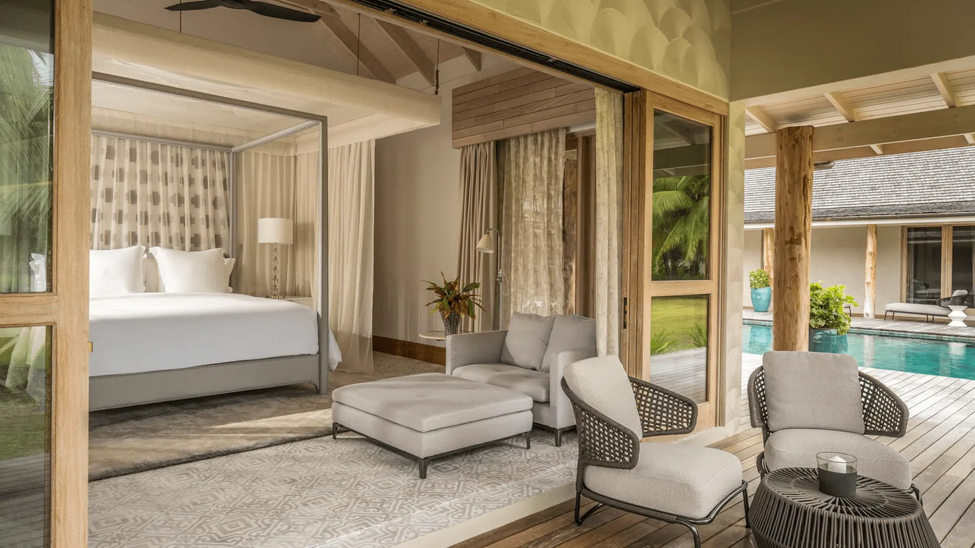 bedroom in a three bedroom presidential villa at four seasons resort desroches seychelles with a large bed and natural light