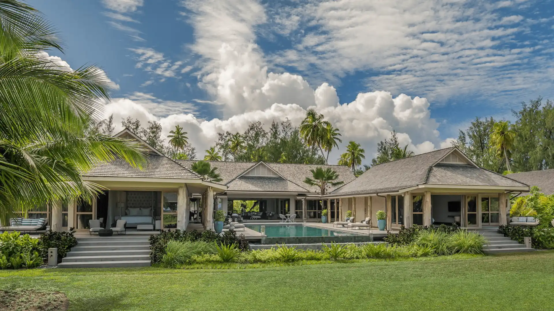 "exterior of a three bedroom presidential villa at four seasons resort desroches seychelles surrounded by tropical greenery and outdoor living spaces