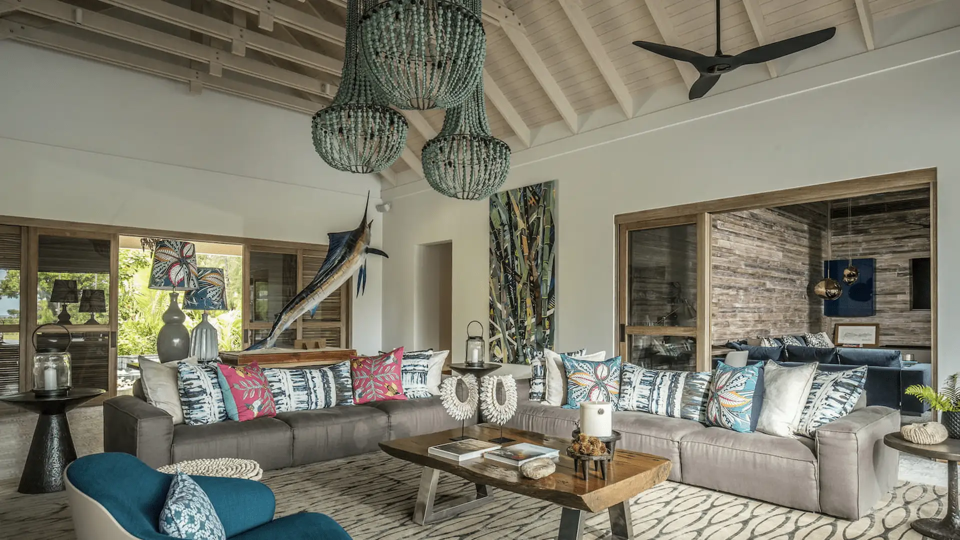 lounge area in a three bedroom presidential villa at four seasons resort desroches seychelles with spacious seating and natural light