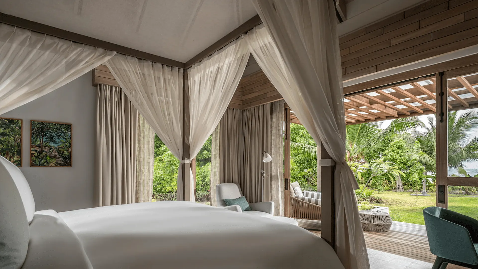 bedroom view in a two bedroom presidential villa at four seasons resort desroches seychelles overlooking the pool and terrace